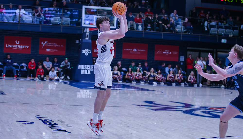 Men's basketball player Alex Ducas shoots