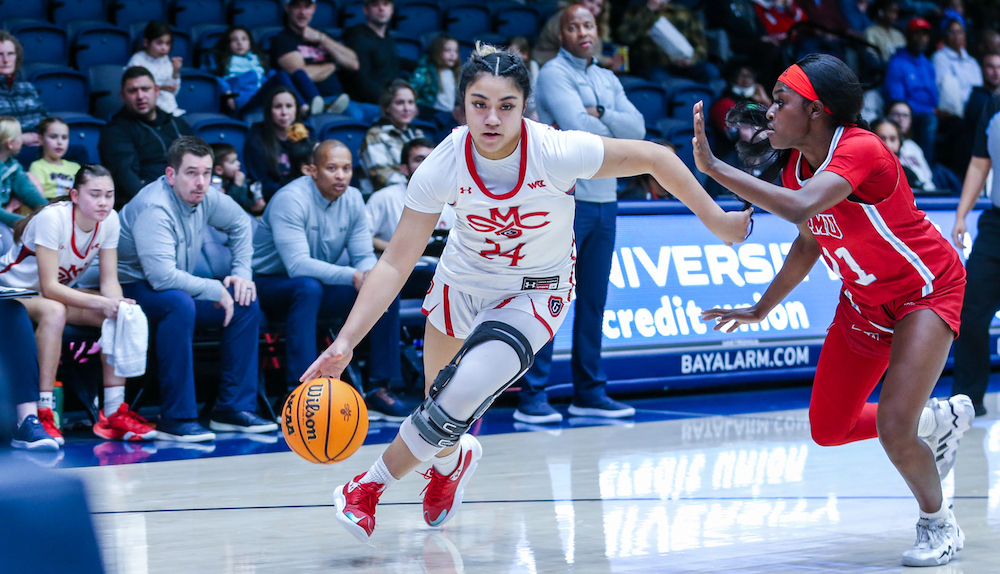 Women's basketball player Zerhyhia Aokuso drives with the ball