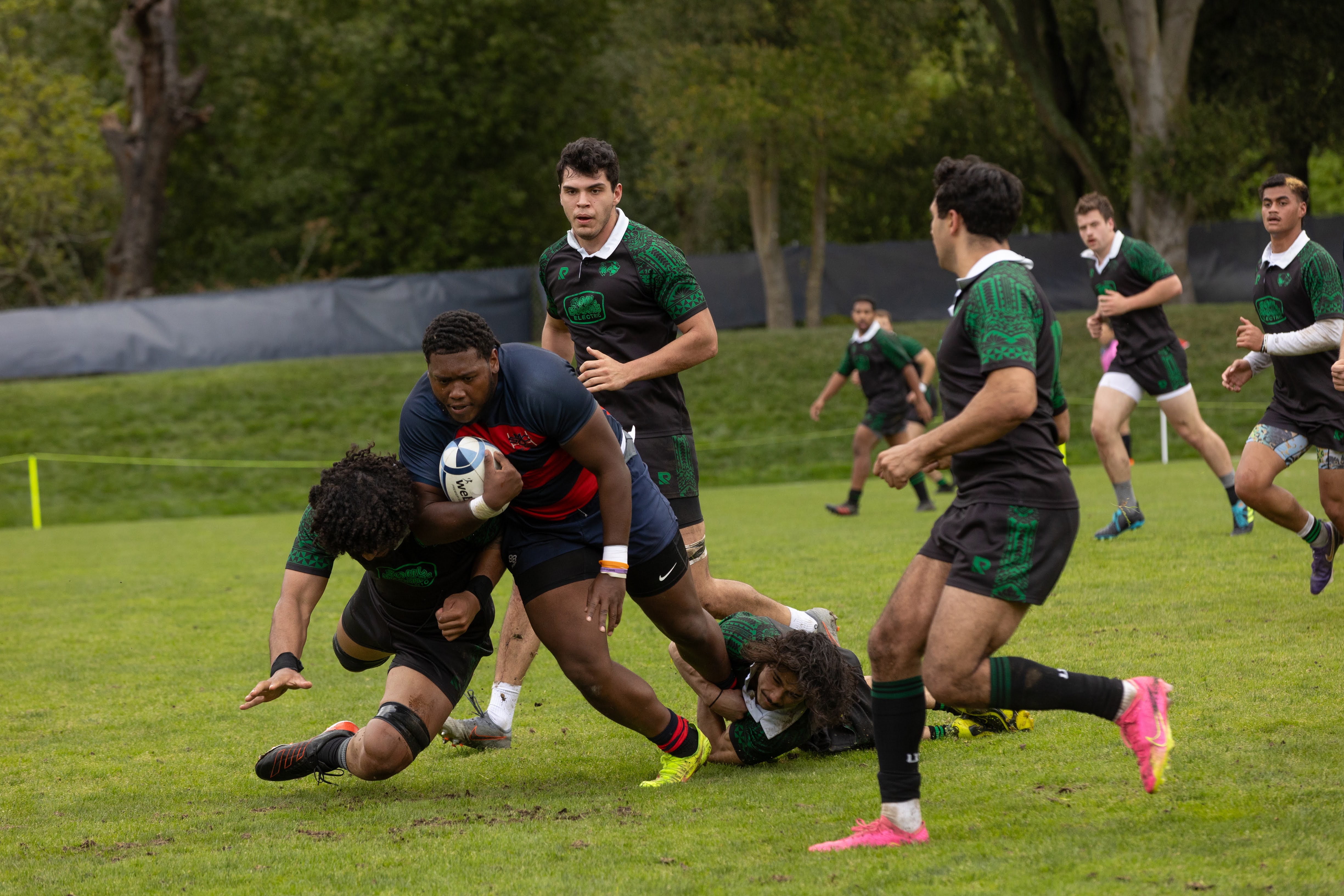John- Henry Rouse drives through the Utah Valley defensive line during the Men's Rugby Game