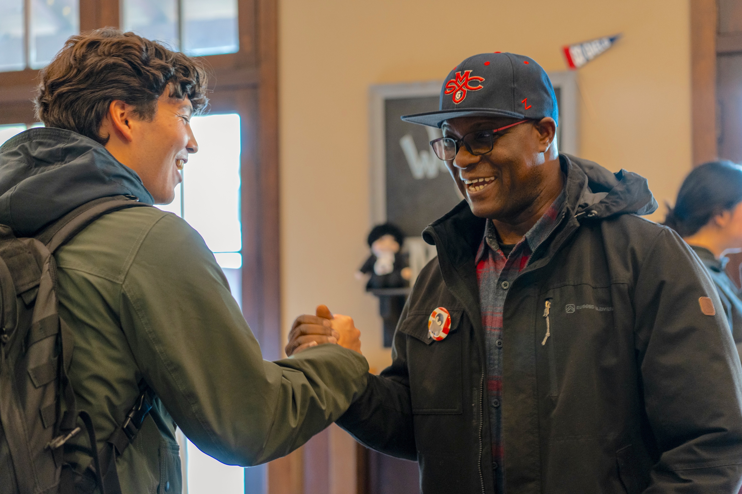 Father Kwame Assenyoh greeting a Saint Mary's student