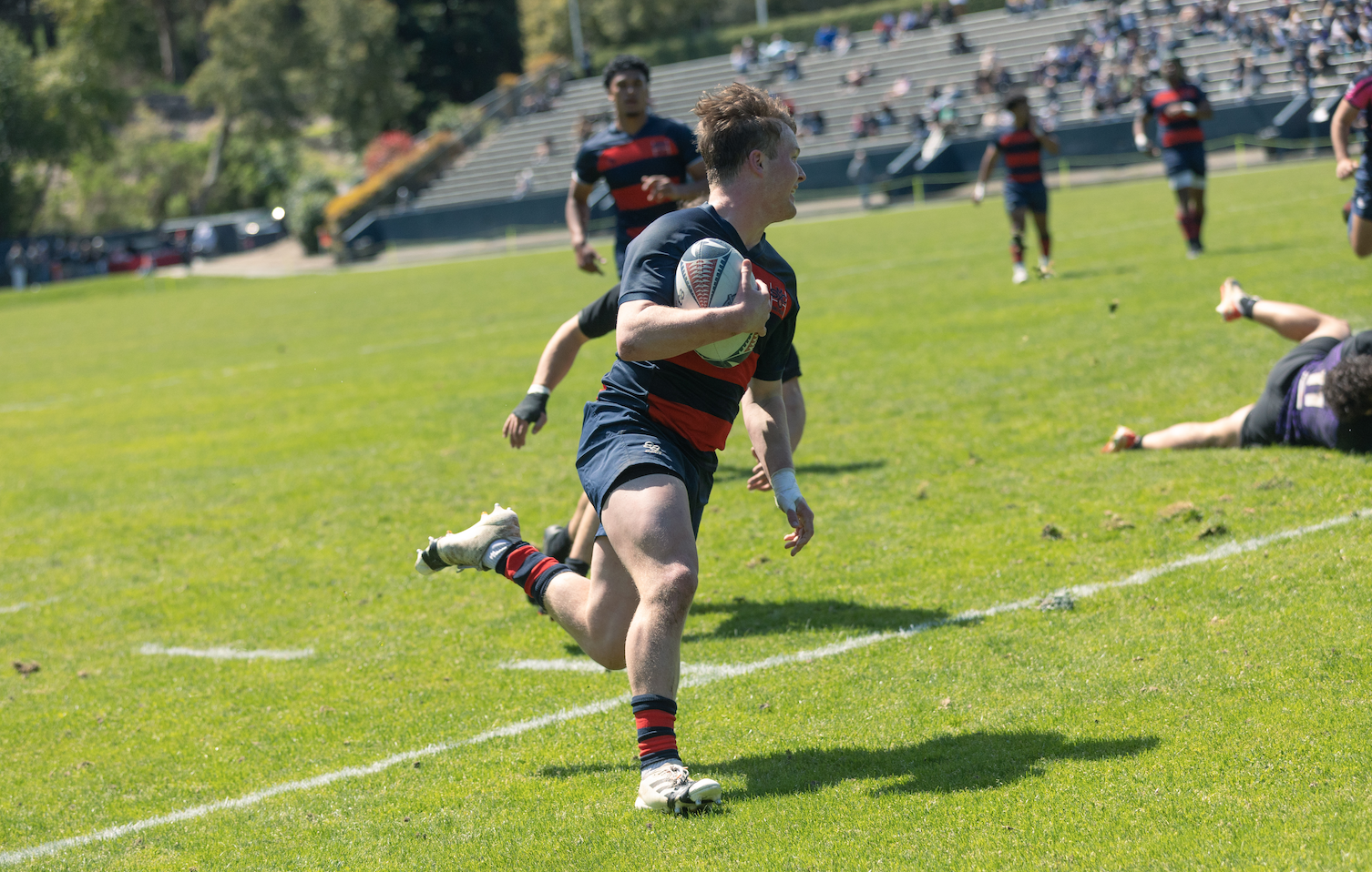 Tatum Pappas runs into the try zone for Men's Rugby