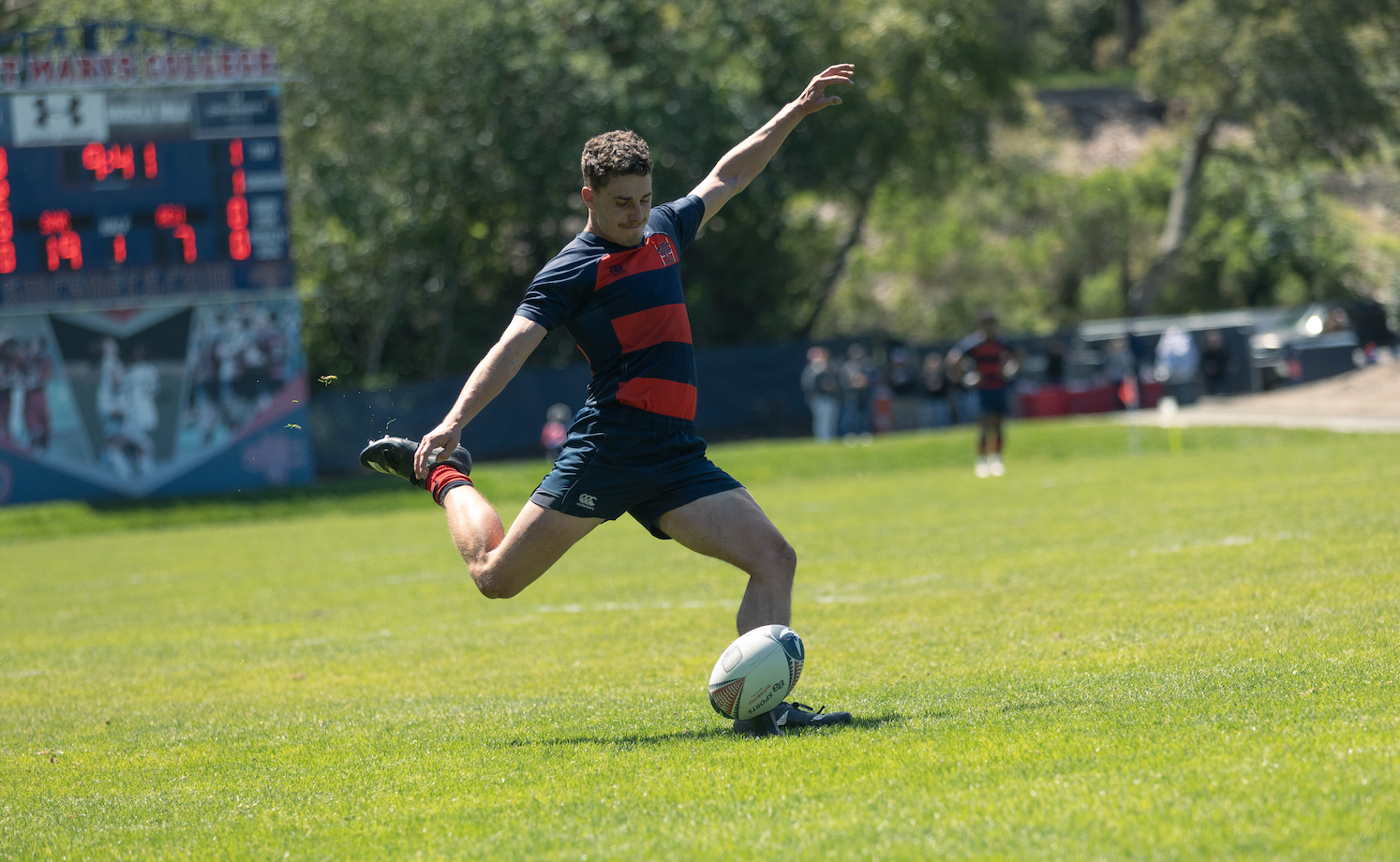 Rugby player kicking the ball