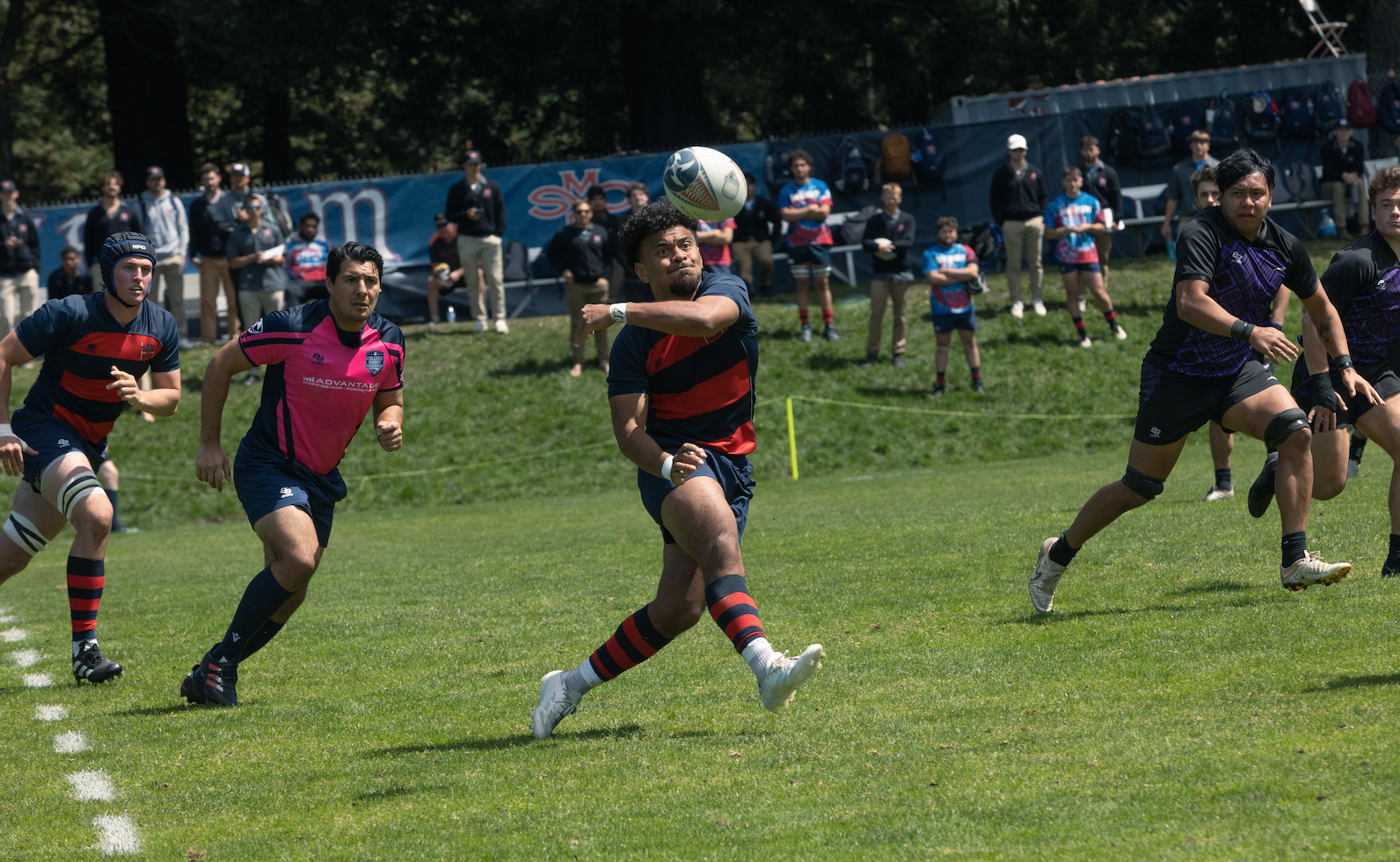 Inoke Waquavesi sends the Spiraling pass to his Rugby teammate
