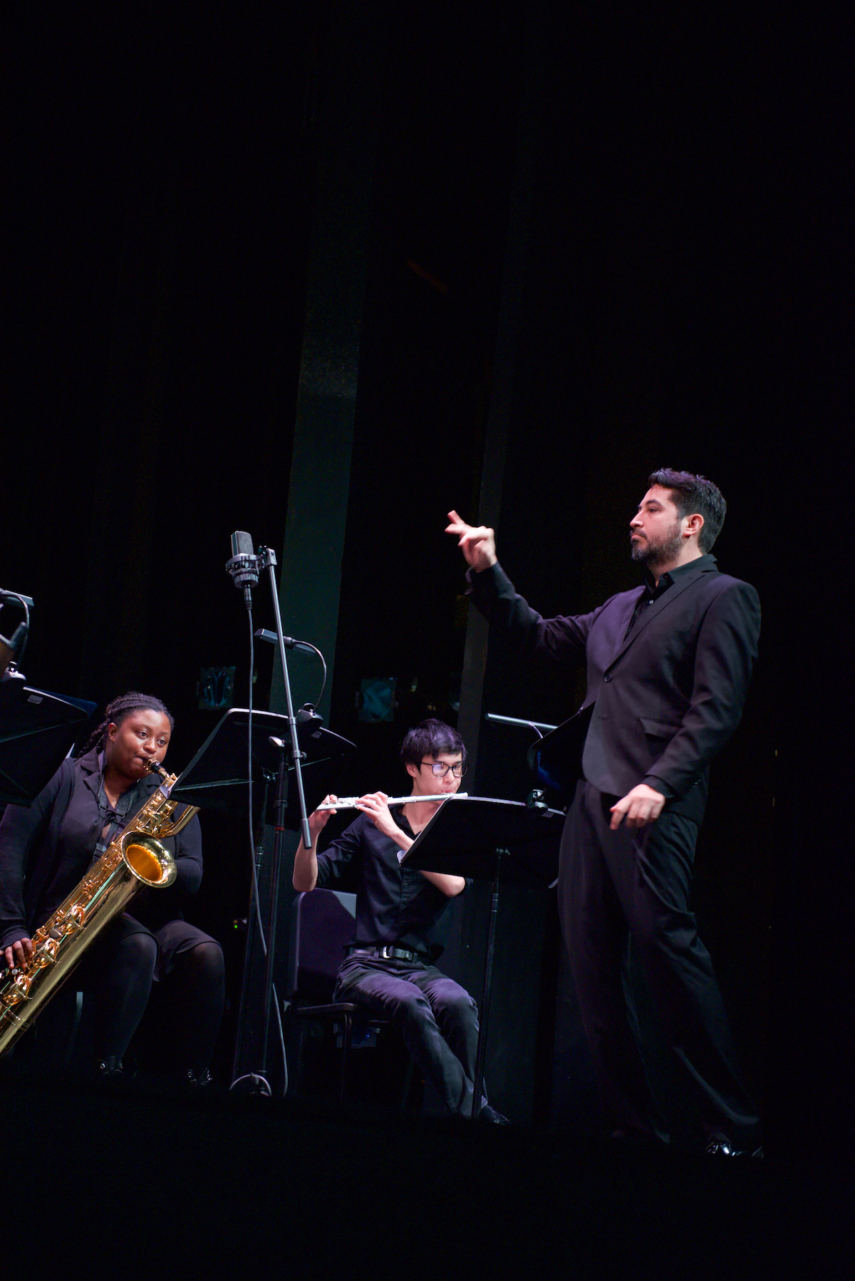 Dr. Sixto F. Montesinos conducting Makaiya Bedford and Michael Welsh with a black background