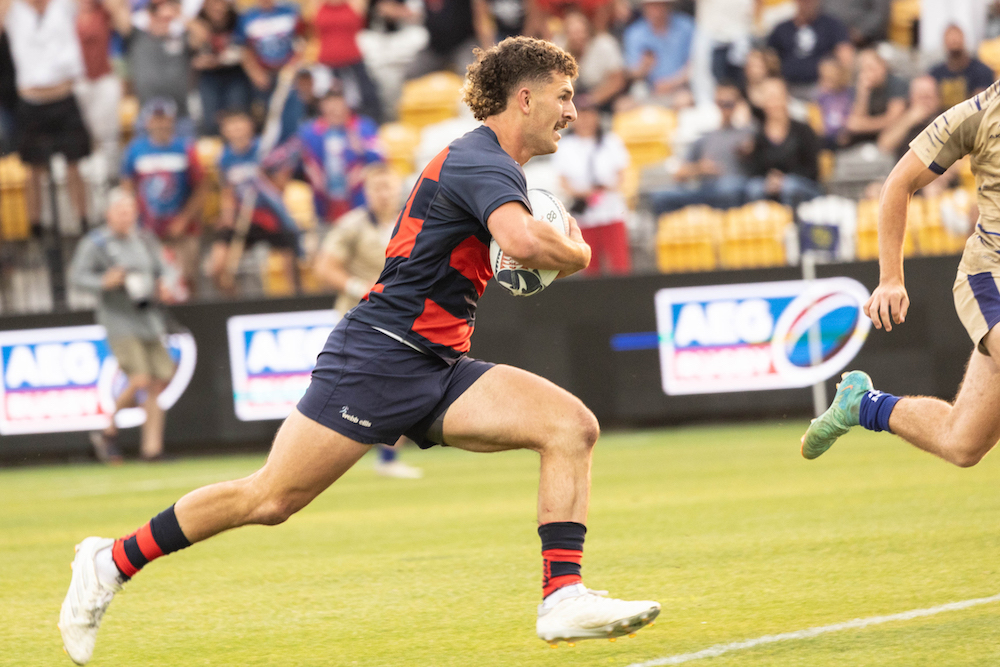 Rugby player Erich Storti runs with the ball in 2024 National Championship