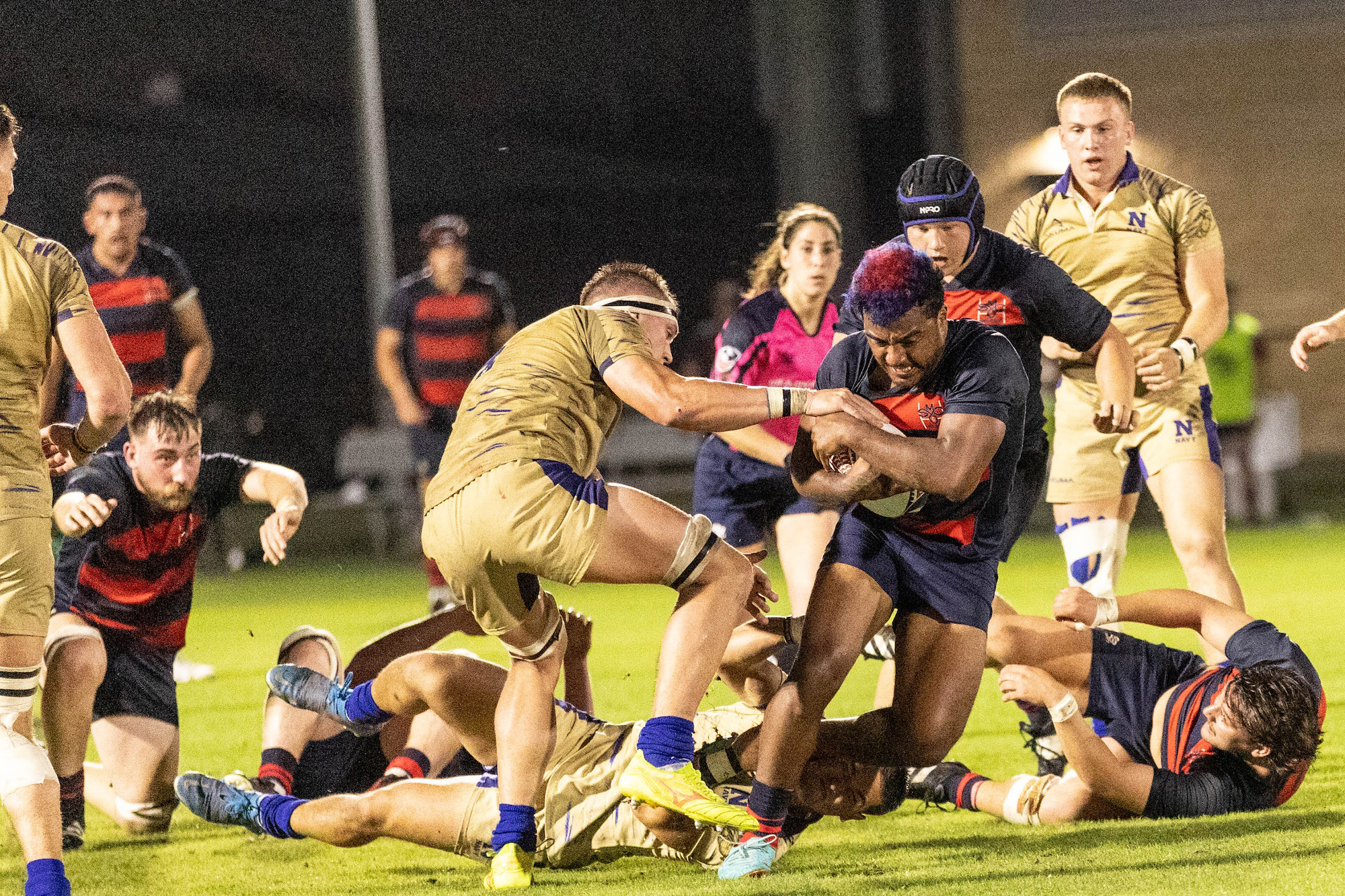 Men's rugby captain Kaipono Kayoshi carries the ball while Navy defenders try to strip it away in 2024 National Championship