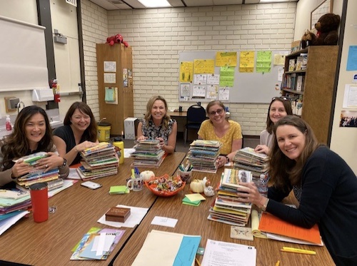 Reading participants around a table with papers