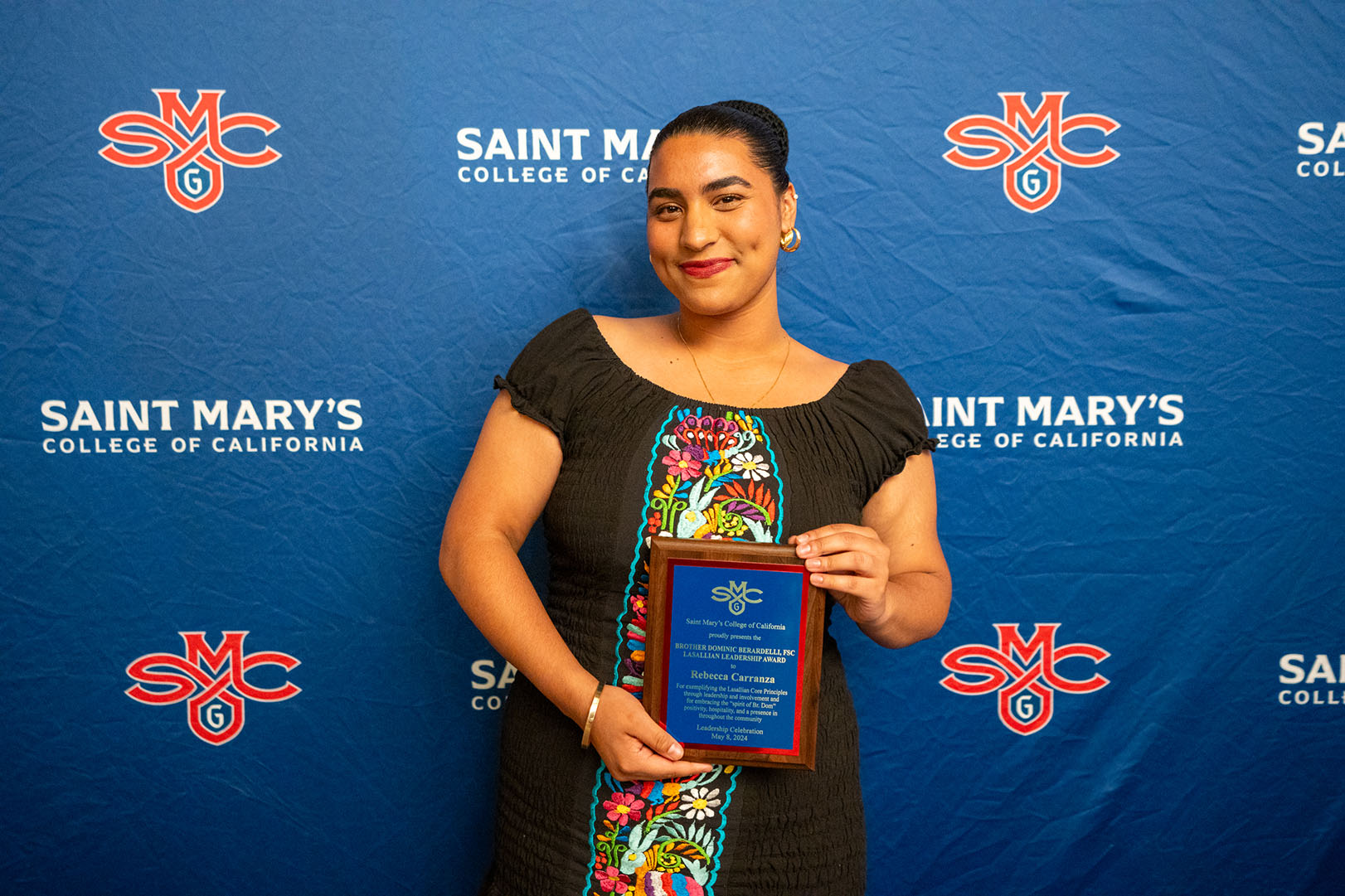 Rebecca Carranza posing with award