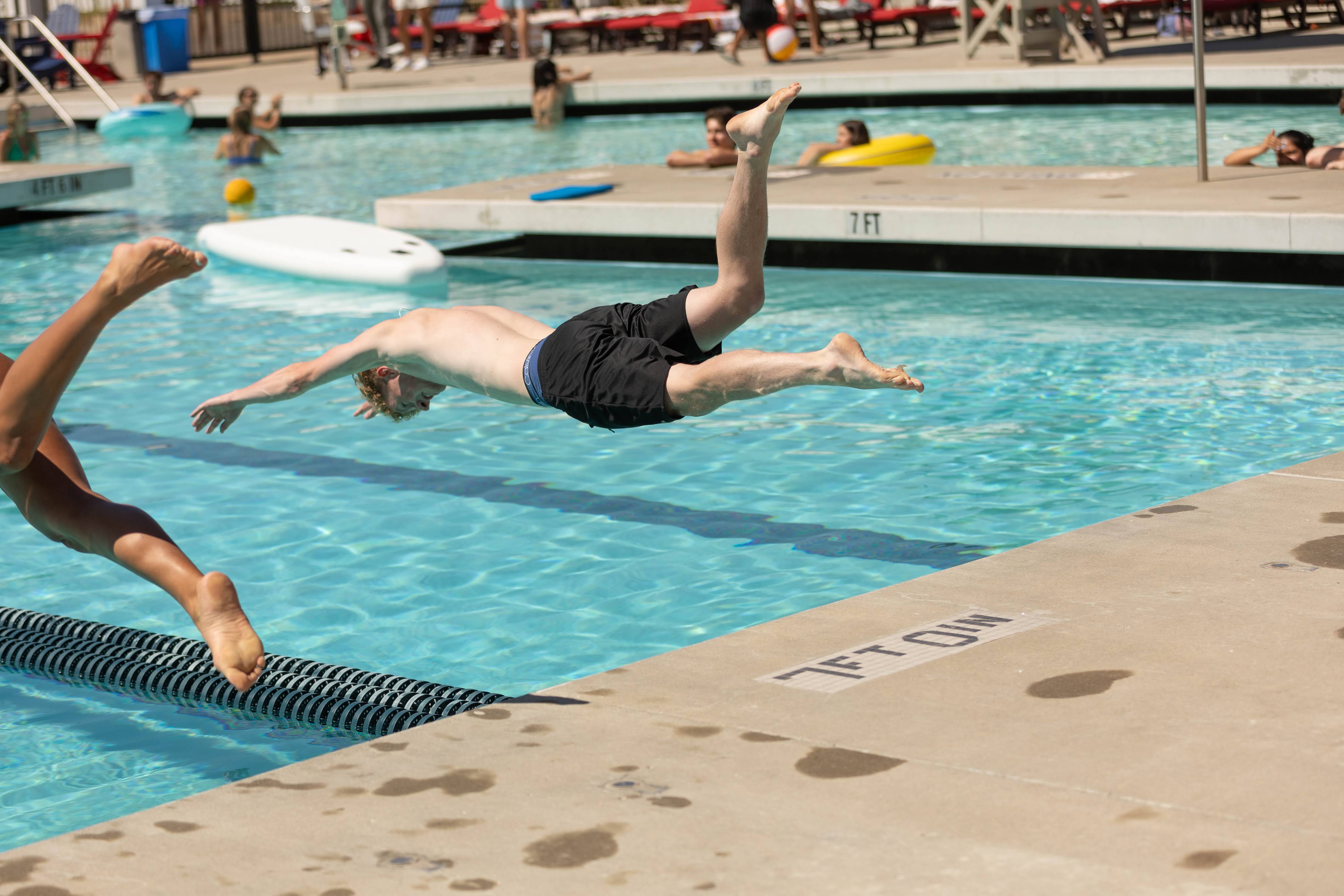 Alec Murphy ' 27 dives into the pool for the 25 yard swim race at the recreation Center
