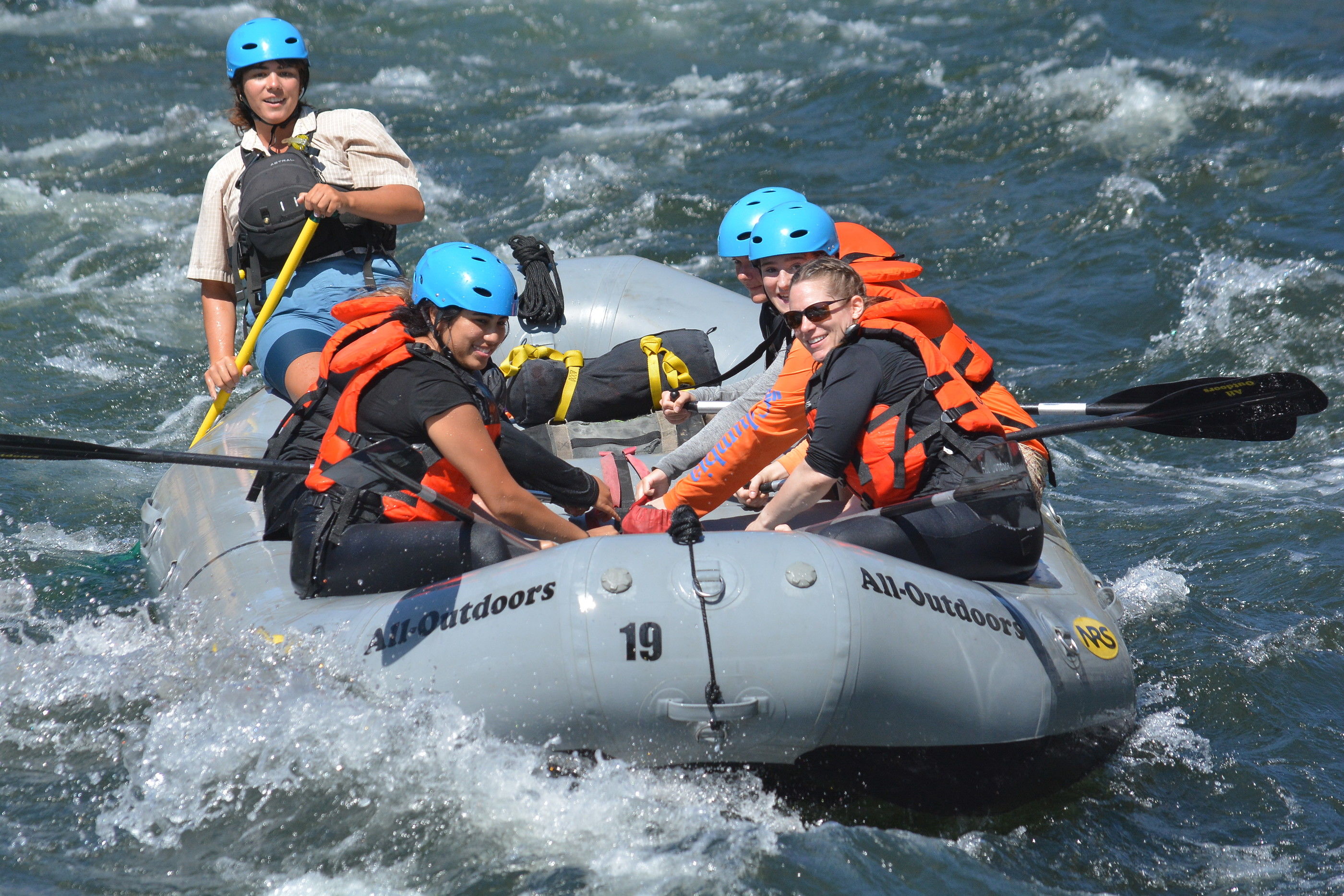 Hold On: Participants prepare for turbulent waters and hold on as the raft guide instructs them for the rapid ahead. / Photo courtesy of Hotshot Images