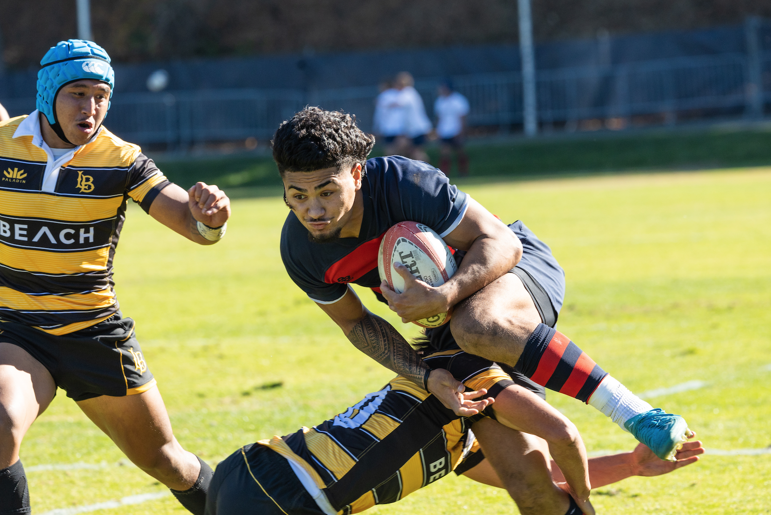 Iosefa Toia’ivao Runs through the defender during the Saint Mary's Rugby Match against Long Beach state.