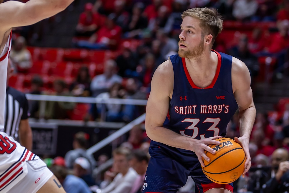 Men's Basketball player Luke Barrett holds ball as SMC plays Utah, December 2024