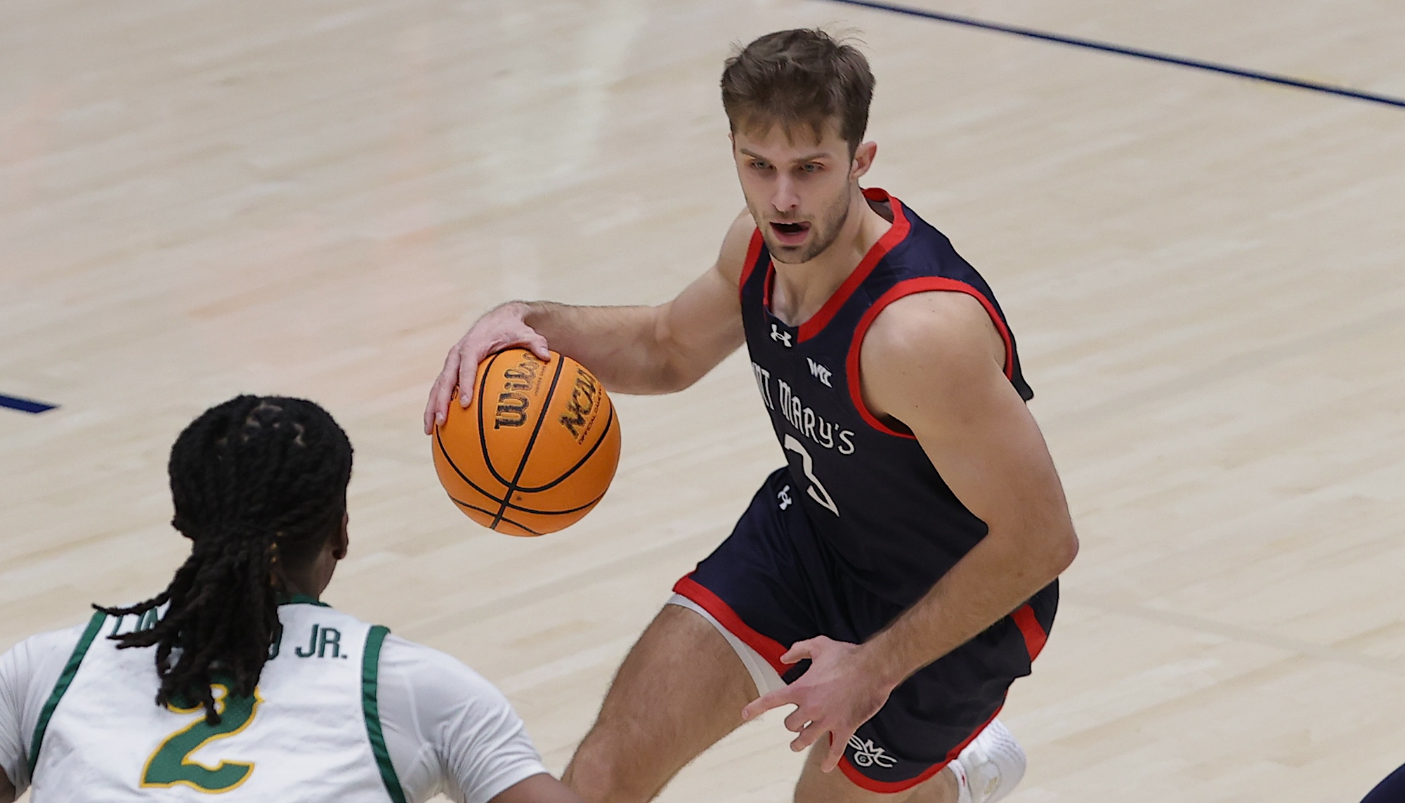 Men's basketball player Augustas Marciulionis drives against USF