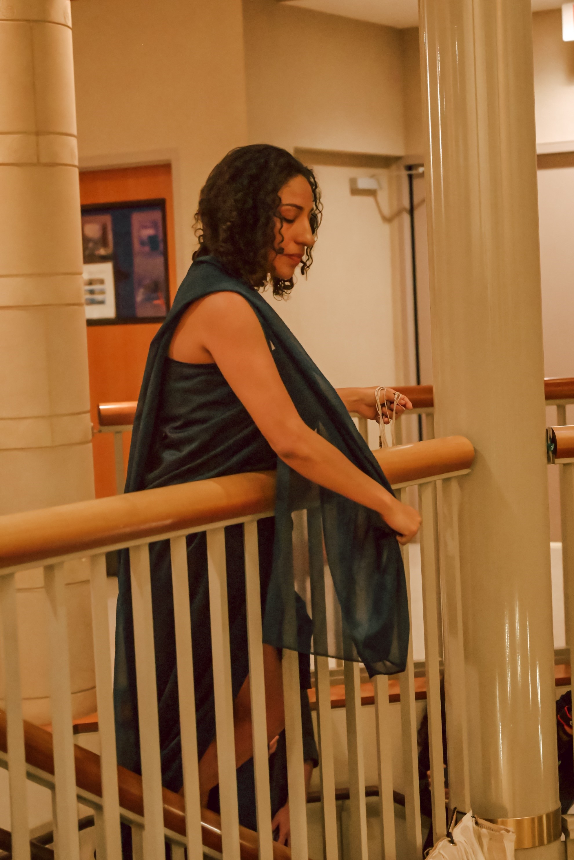 Photo of MFA alumni Nefertiti Altan reaching down during her thesis performance.