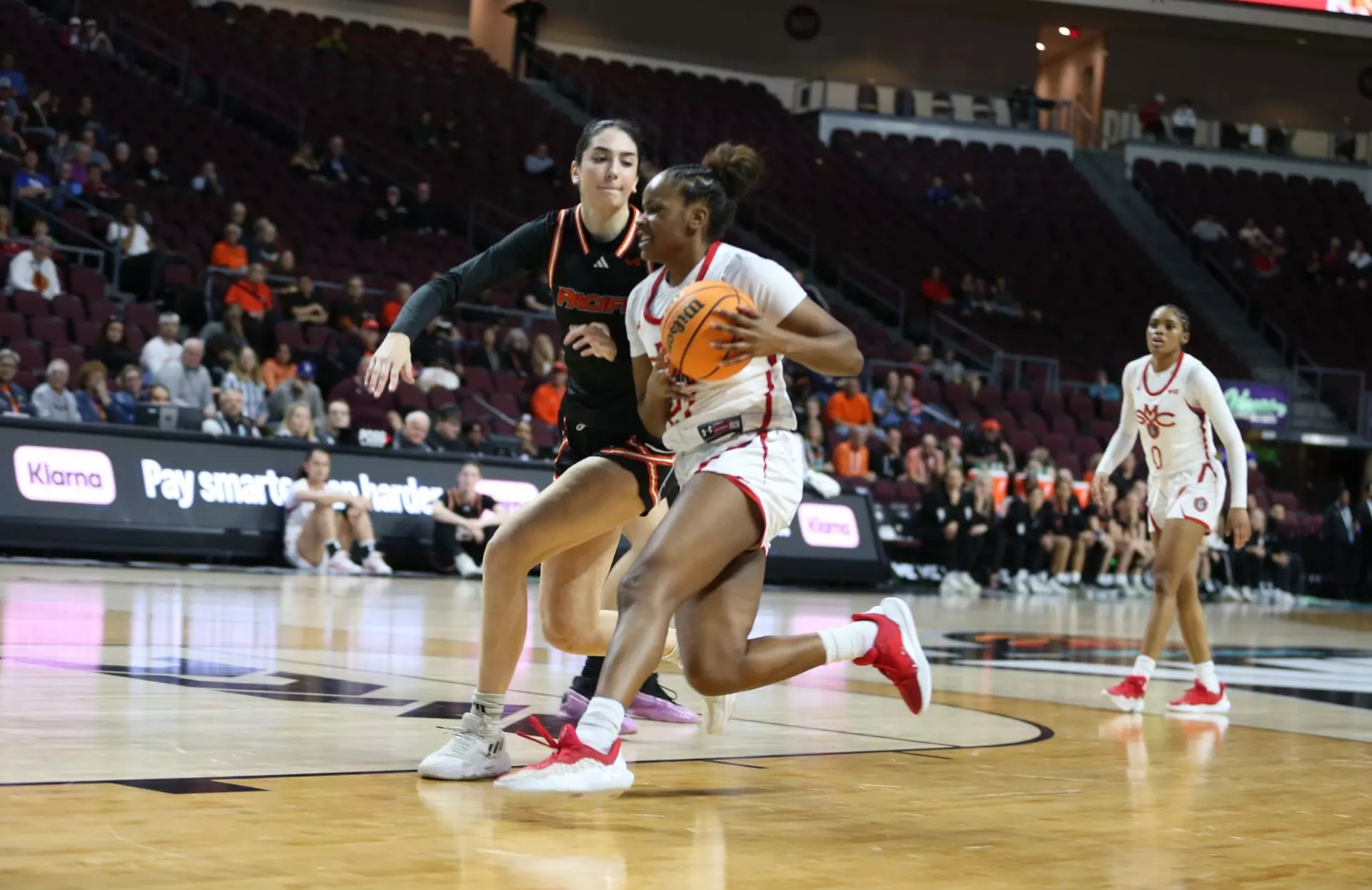 Women's basketball player Kennedy Johnson drives against Pacific in 2024-25 season