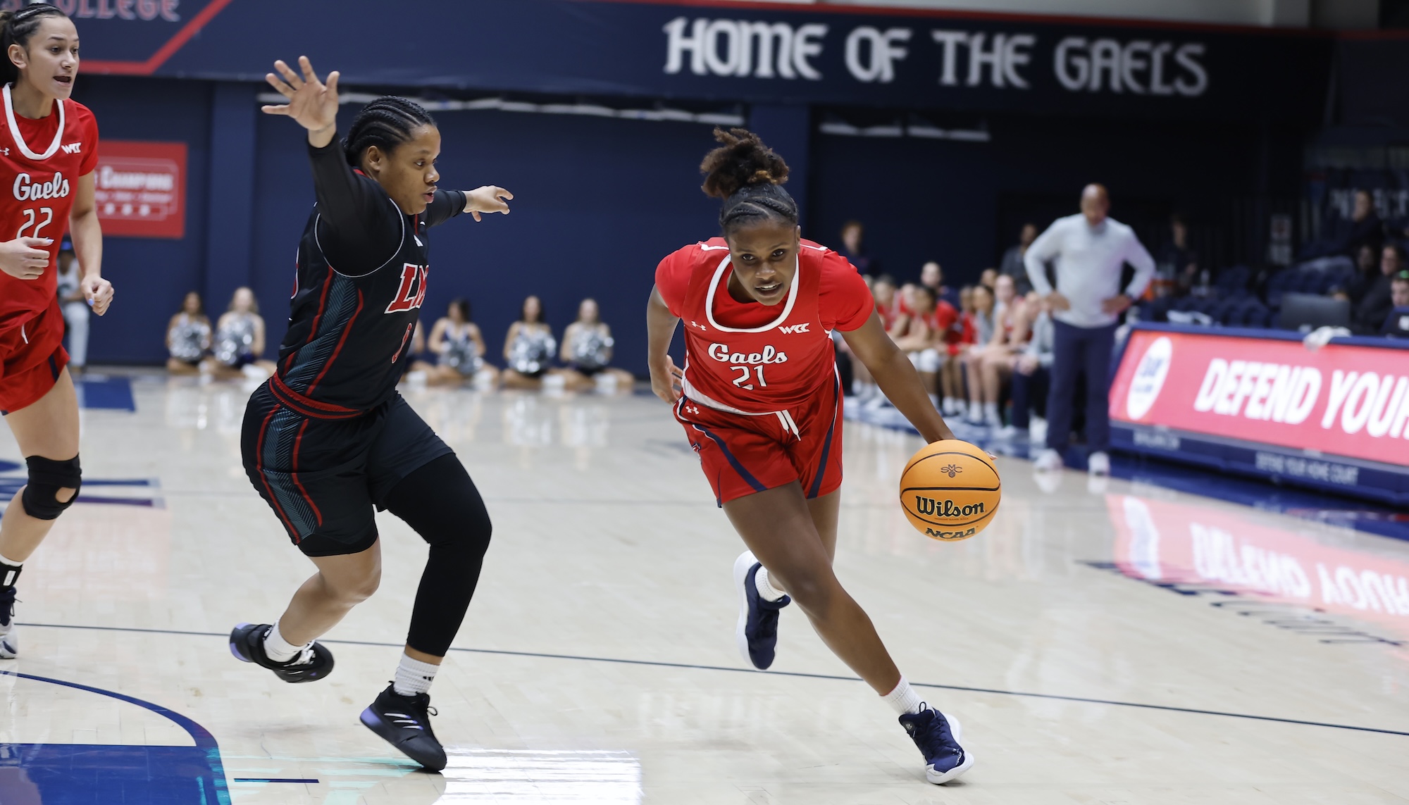 SMC Women's Basketball player Kennedy Johnson drives against LMU in January 2025