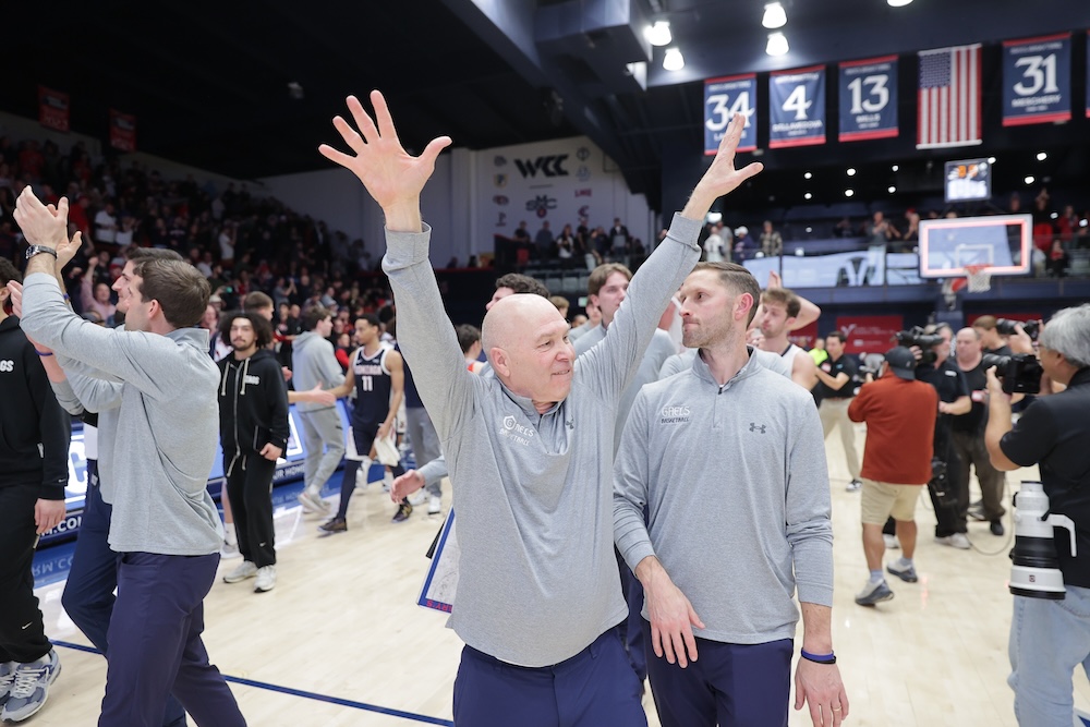 Men's Basketball Head Coach Randy Bennett raises arms in victory over Gonzaga in February 2025
