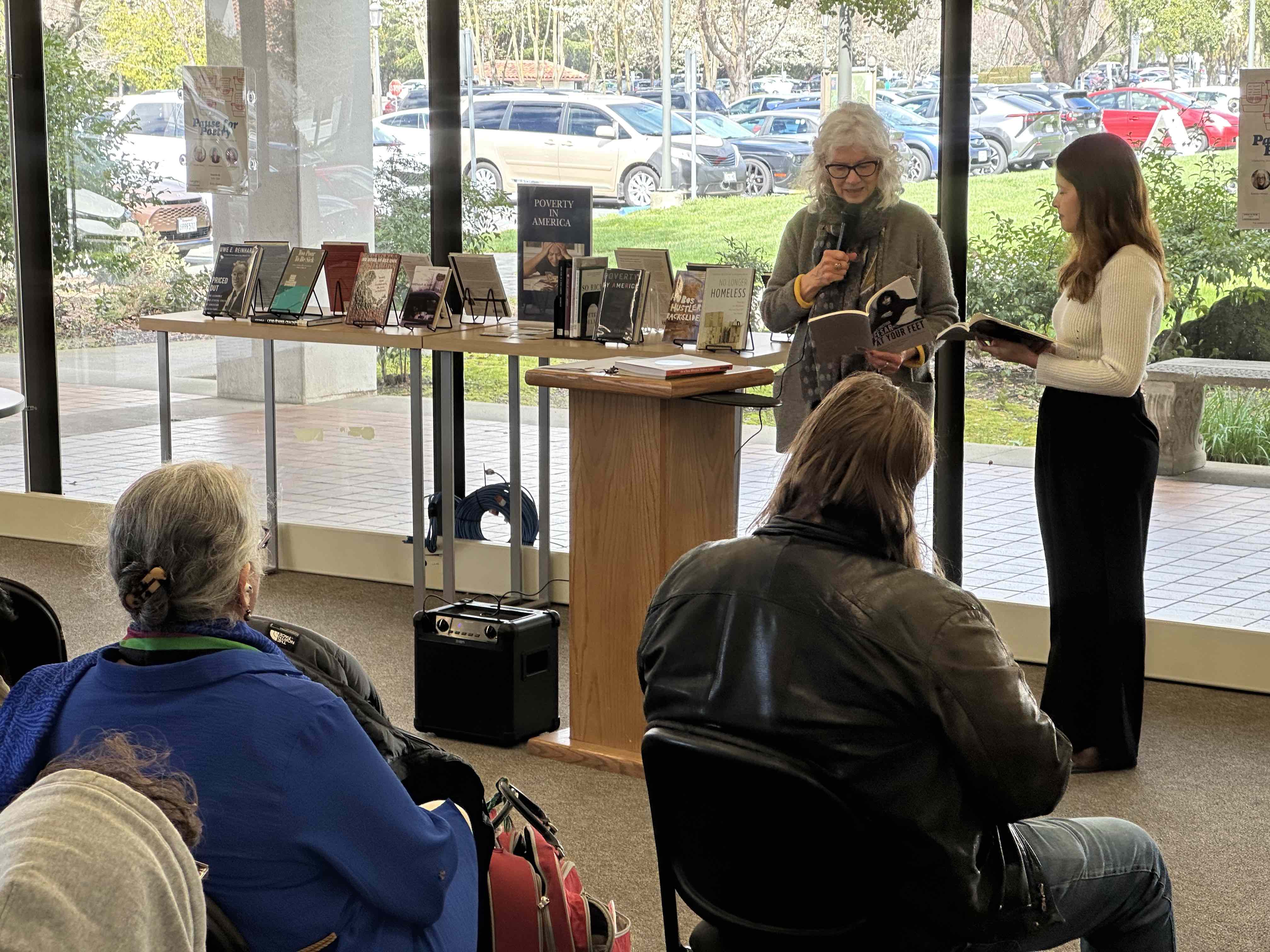Brenda Hillman and Alana Rodriguez read in front of a crowd
