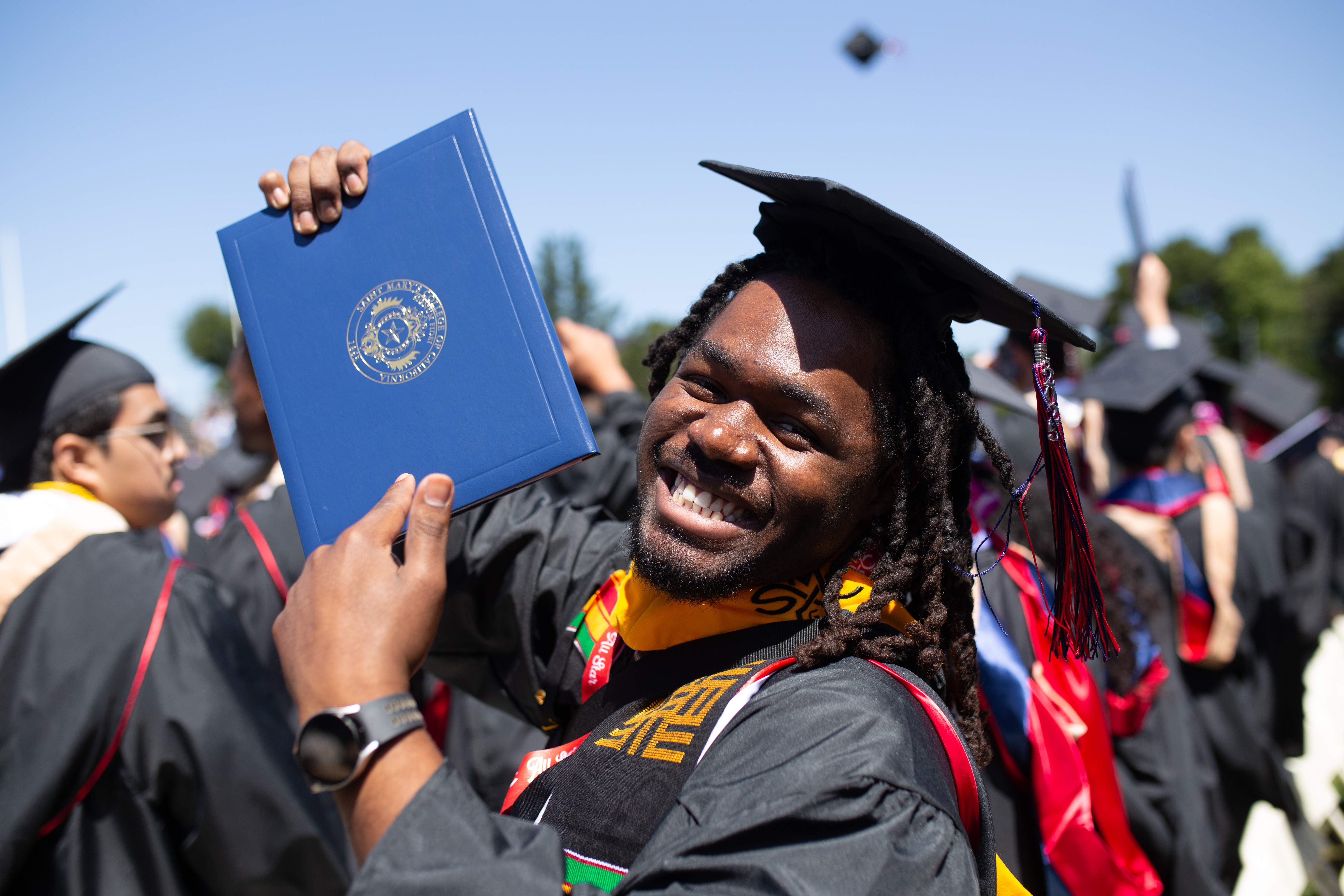 Student holding up diploma at Saint Mary's Undergraduate Commencement 2025