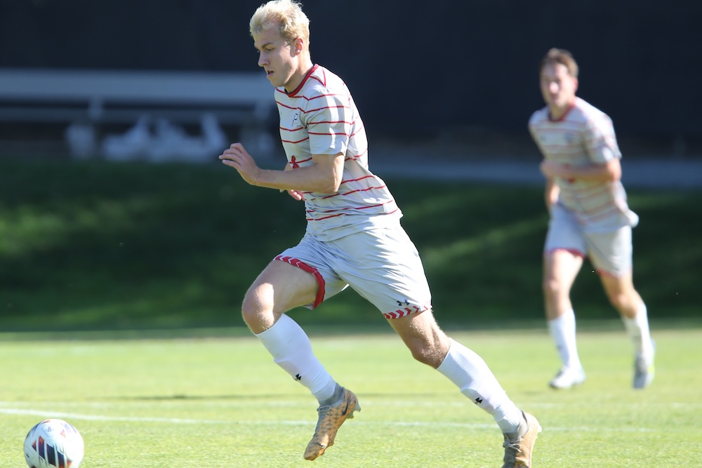 Men's Soccer Player Bastian Toelhoej dribbles the ball against USF in November 2024