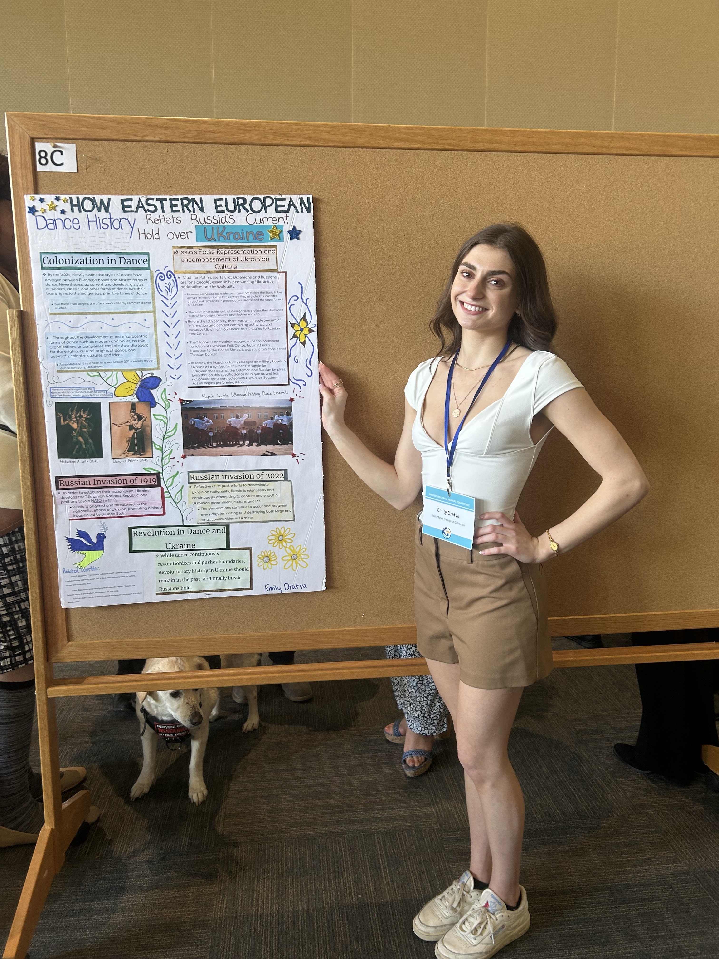 Student in front of a conference poster presentation