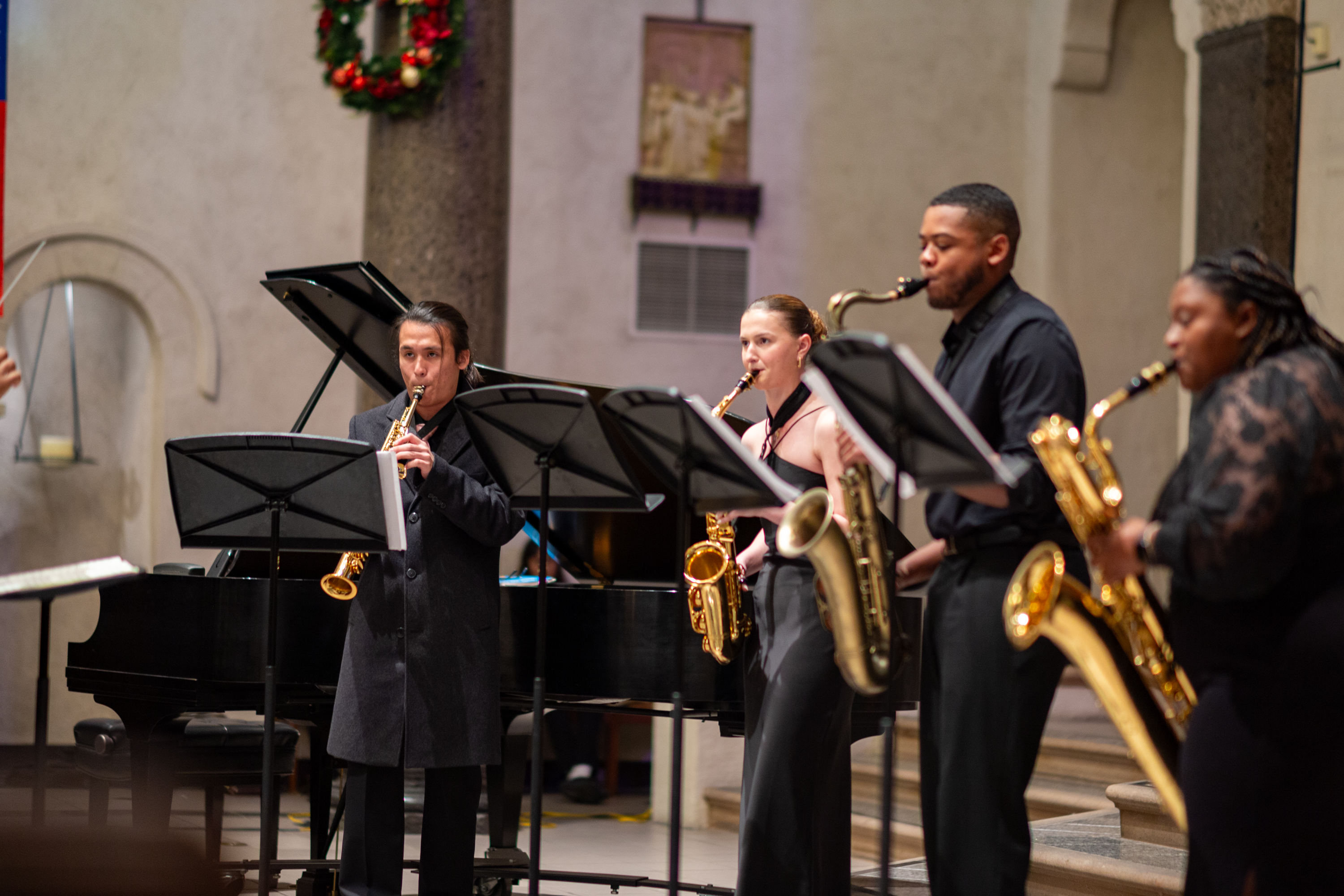 Four music students performing in the Chapel