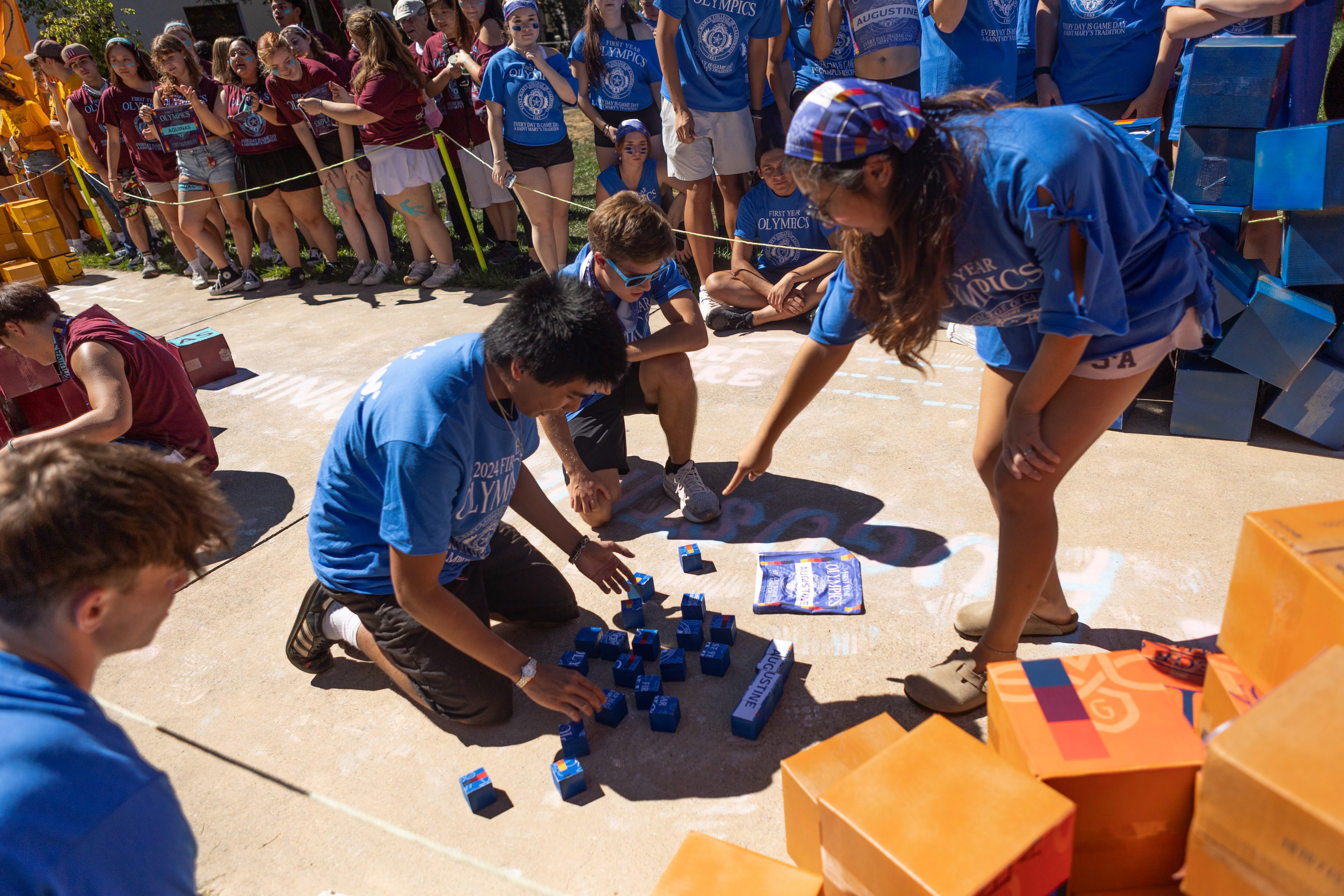 Puzzle Pizazz: Augustine Hall students work together to complete the square puzzle relay, but fell short to Mitty Hall during the First Year Olympic event at Saint Mary’s College. / Photo by Rebecca Harper