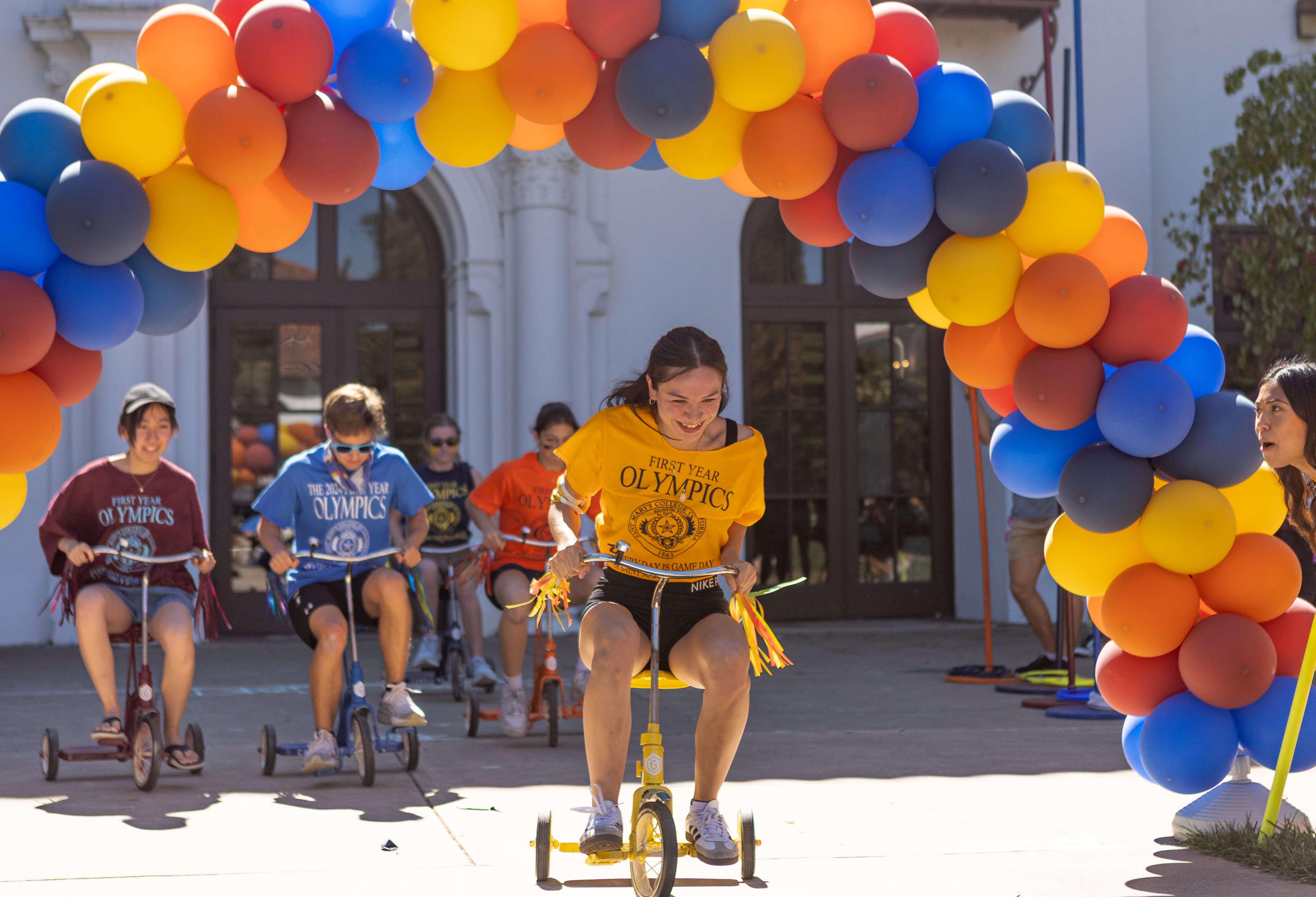 Paola Quintero ‘29, representing De La Salle hall in the lead during the tricycle race at the First Year olympic event on Sept 14, 2025. / Photo by Rebecca Harper