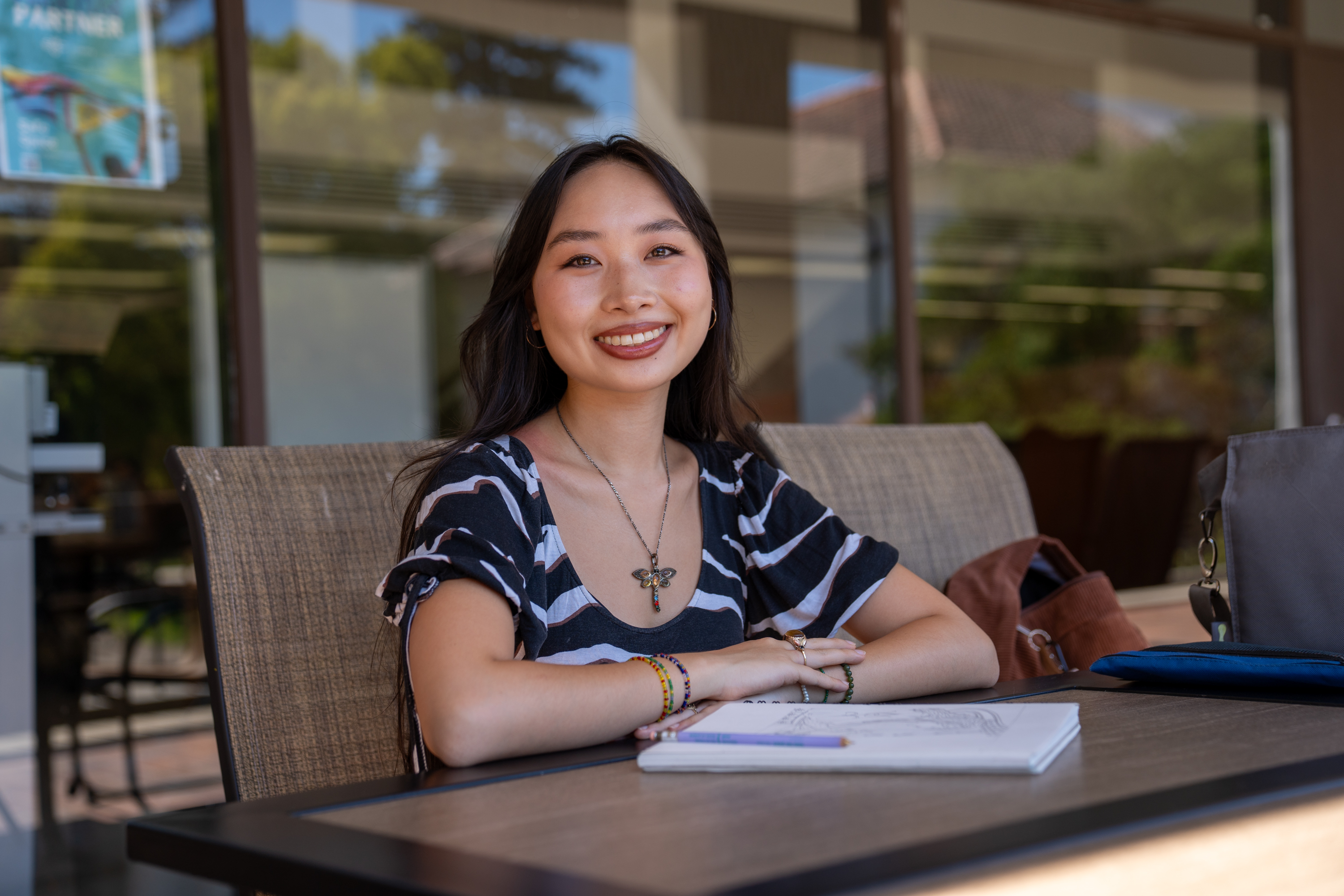 Isabelle Ly sitting outside library