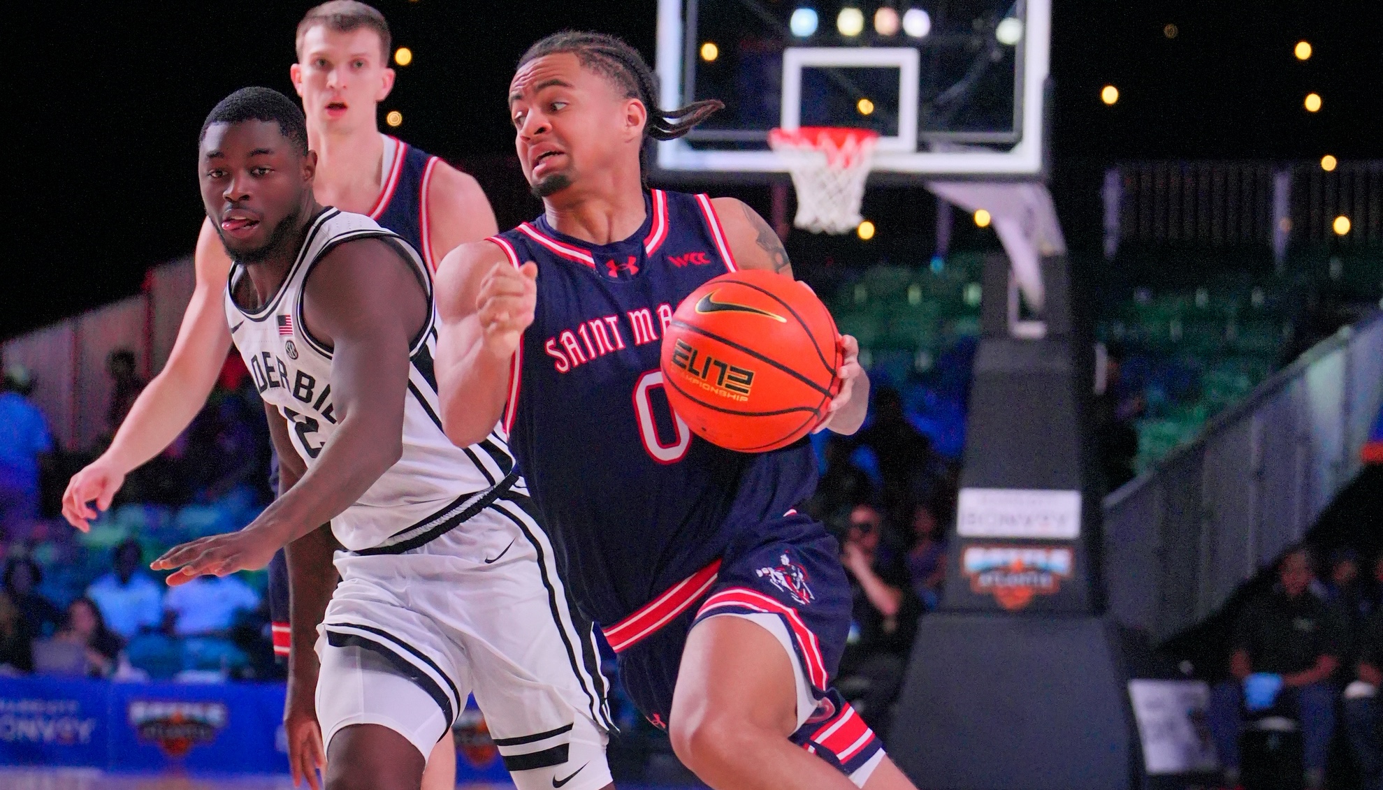 Basketball player Mikey Lewis drives against Vanderbilt in November 2025