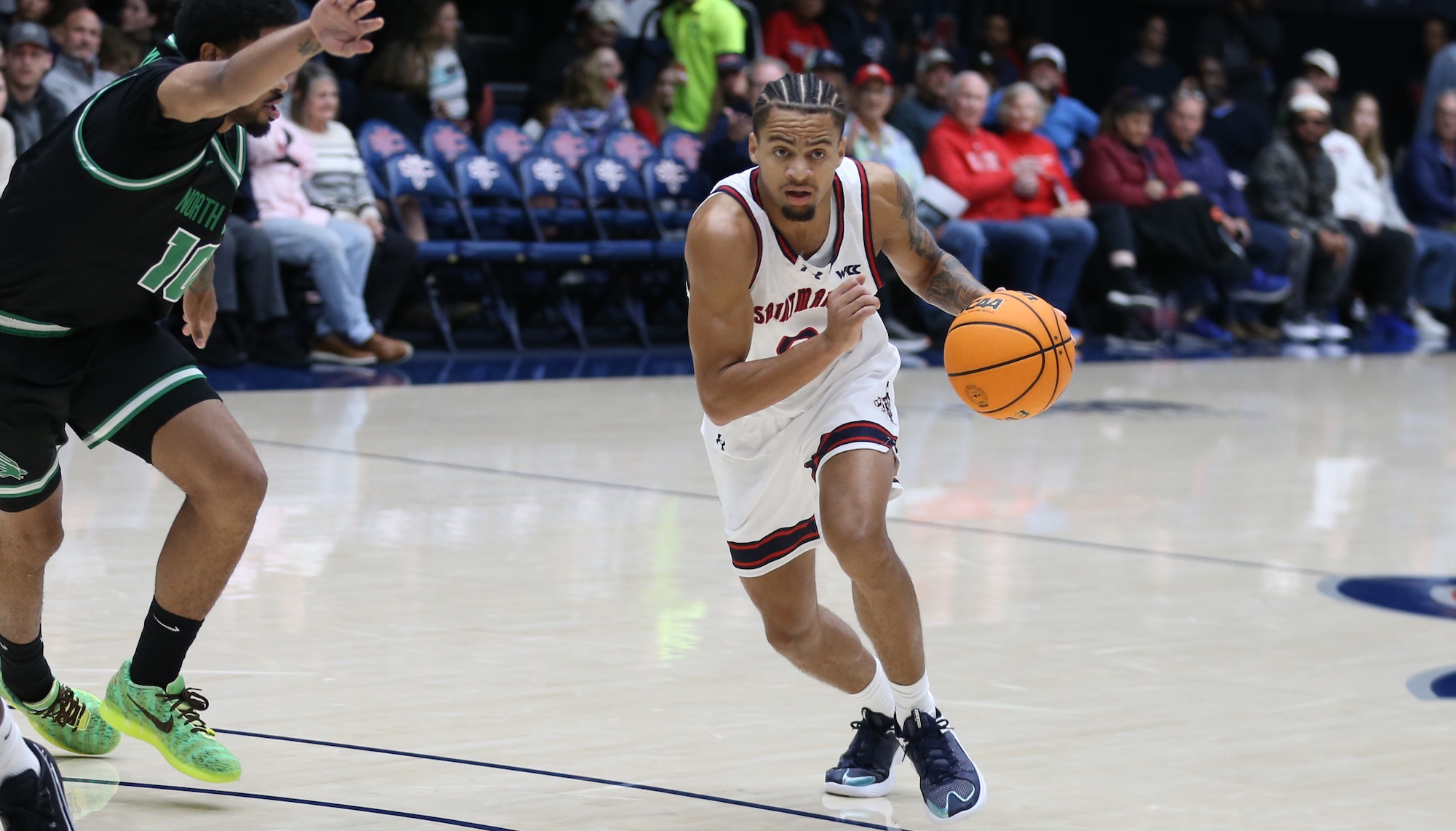 Men's Basketball player Mikey Lewis drives against North Texas in November 2025