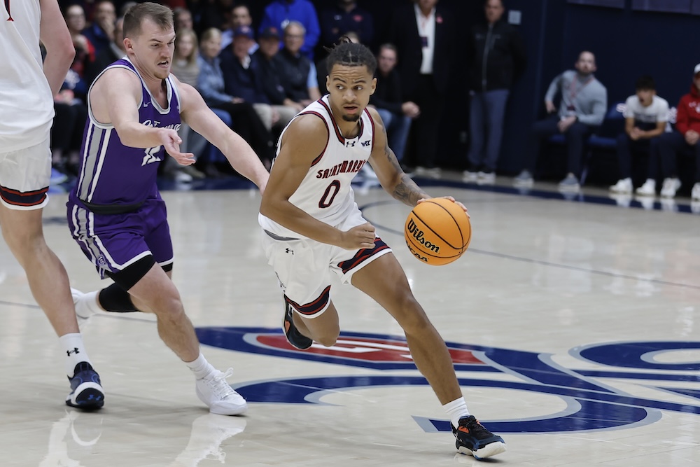 Men's Basketball Player Mikey Lewis drives against St. Thomas on Nov. 3, 2025