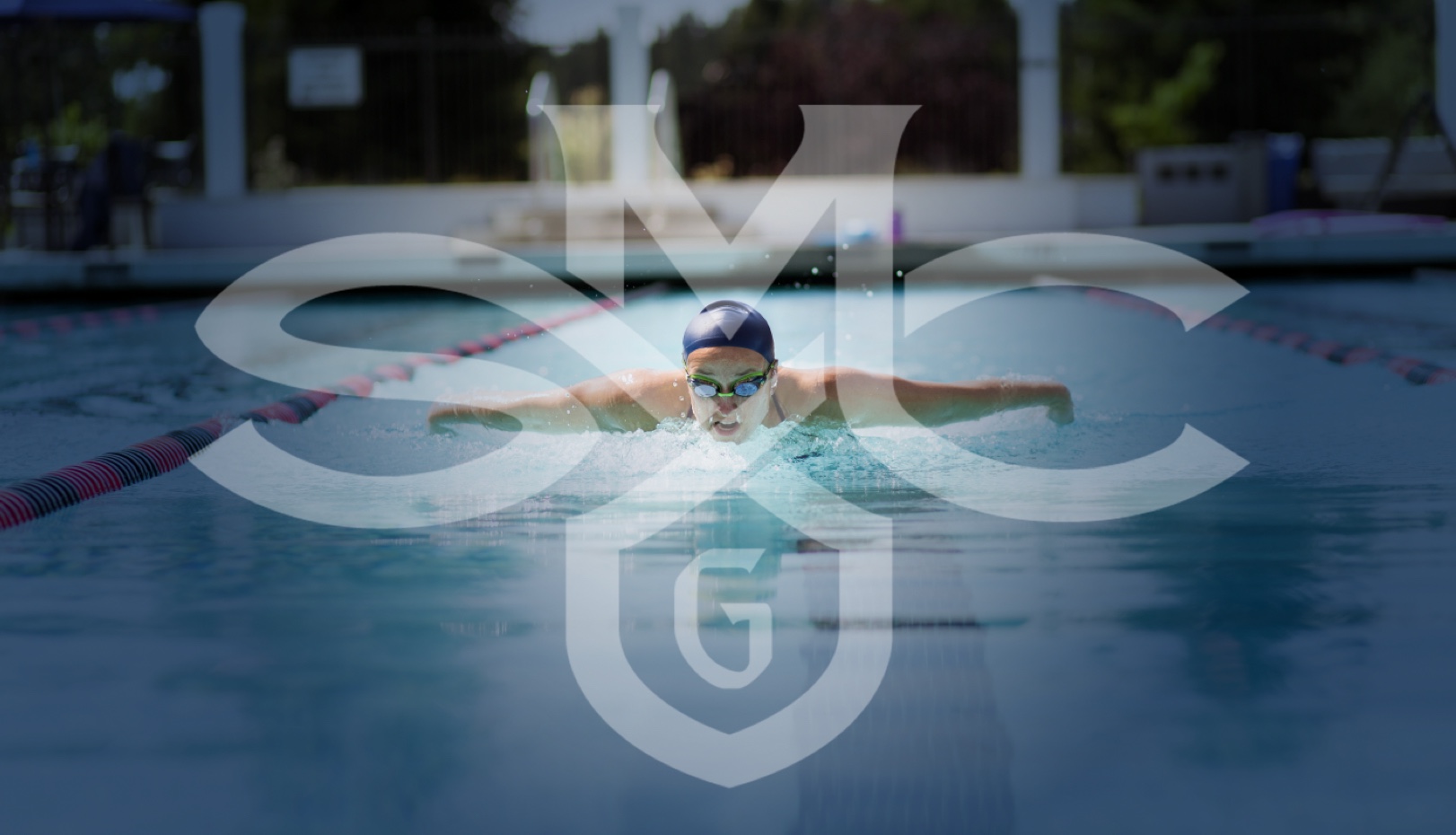 Swimmer in pool with SMC logo over it