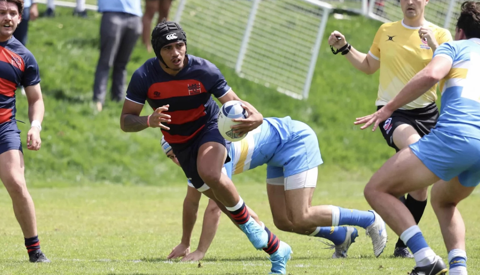 Sialeafuhia Ofa ’28 carries the ball past UCLA defenders