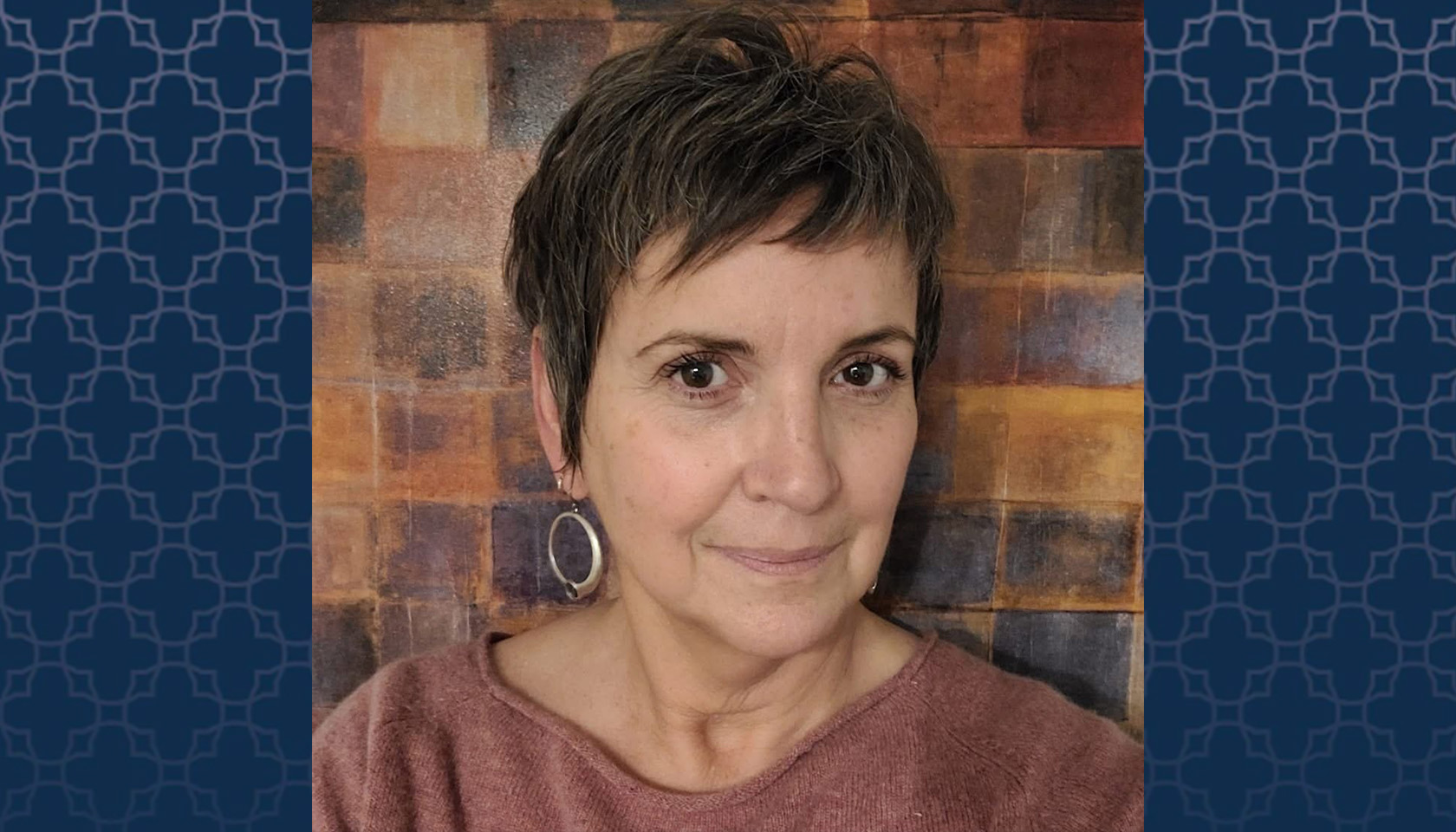 Professor Sheila Hassell Hughes with blue patterned background on sides