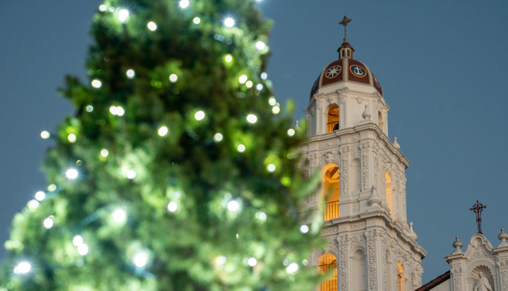 Holiday tree in lights with SMC chapel tower in background