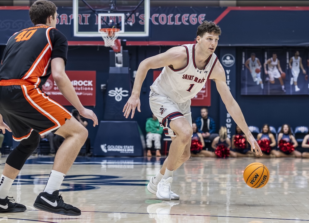 Basketball player Harry Wessels dribbles past an OSU player in January 2026