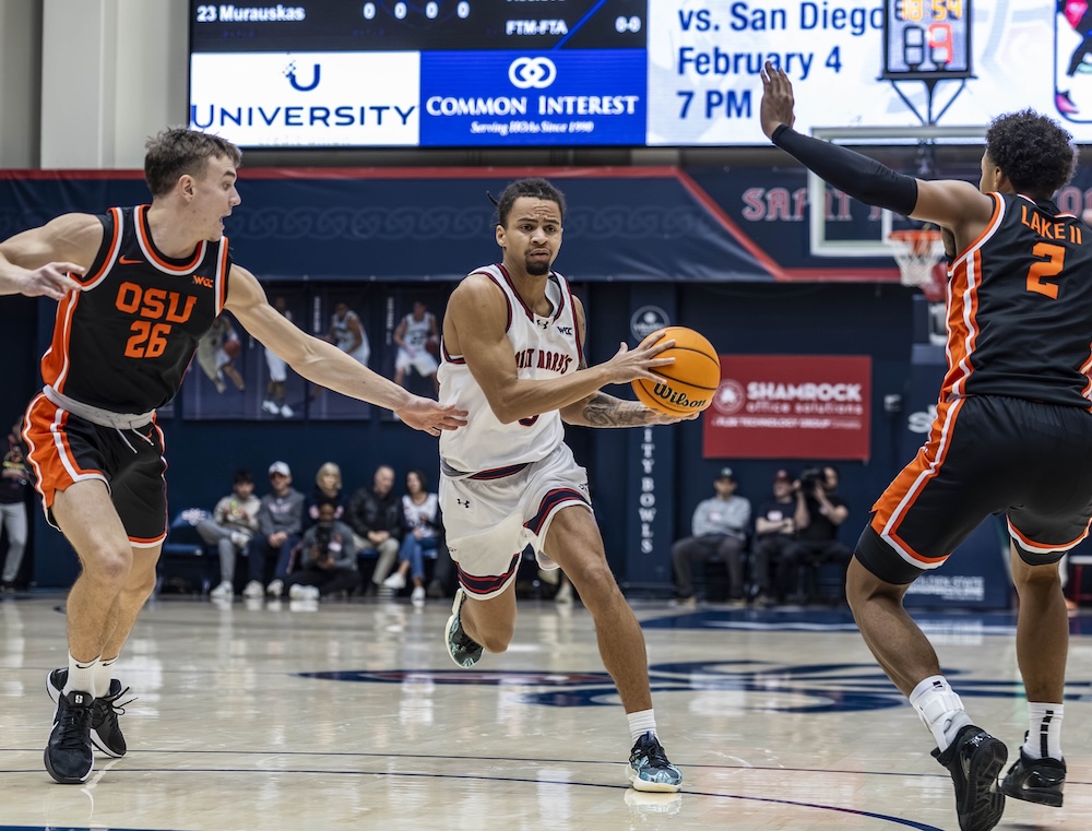 Basketball player Mikey Lewis drives against OSU in January 2026