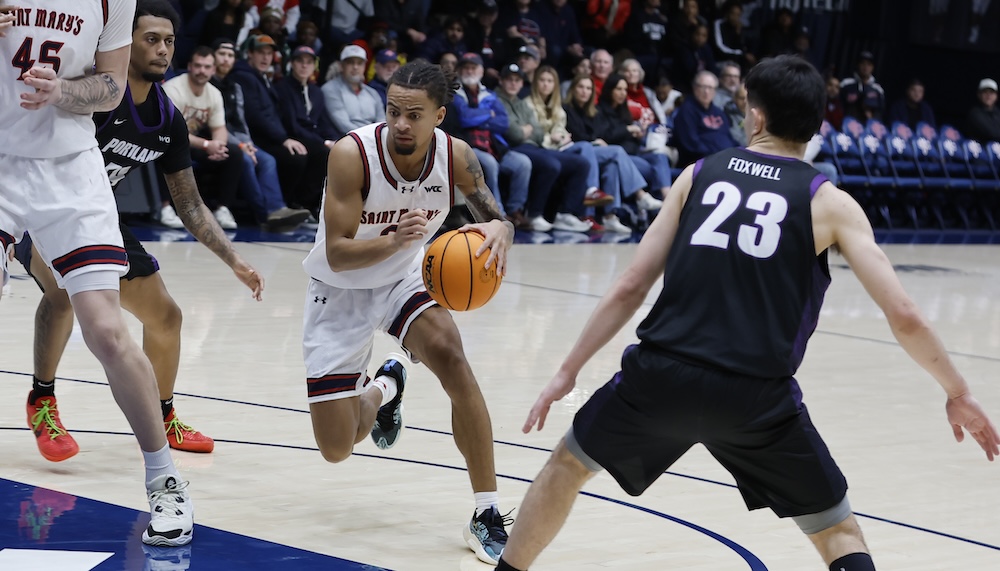 Basketball player Mikey Lewis shoots against Portland in January 2026