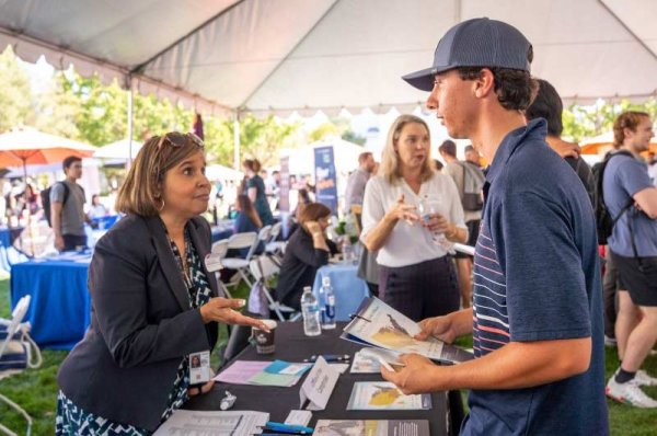 A student meeting with an employer at career fair