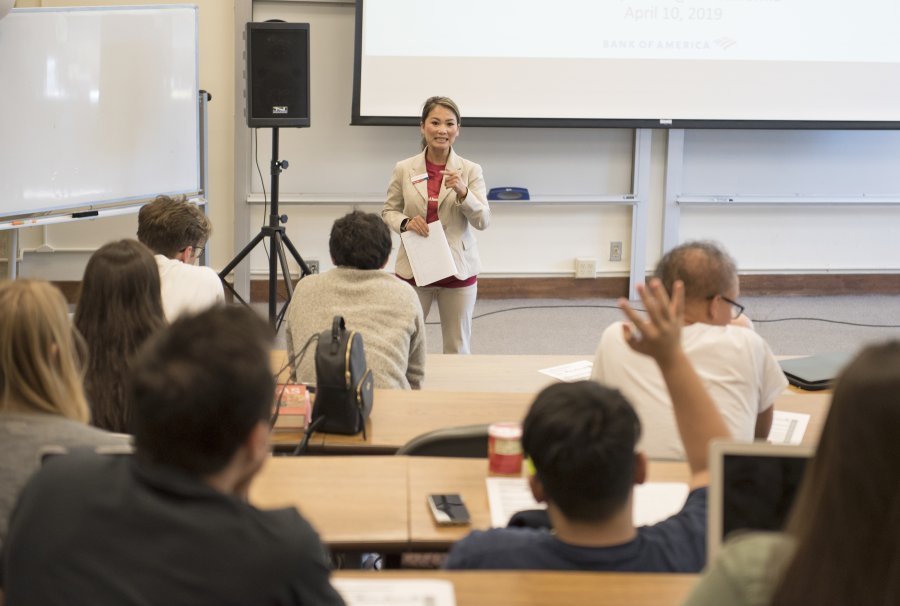 A woman giving a lecture to students