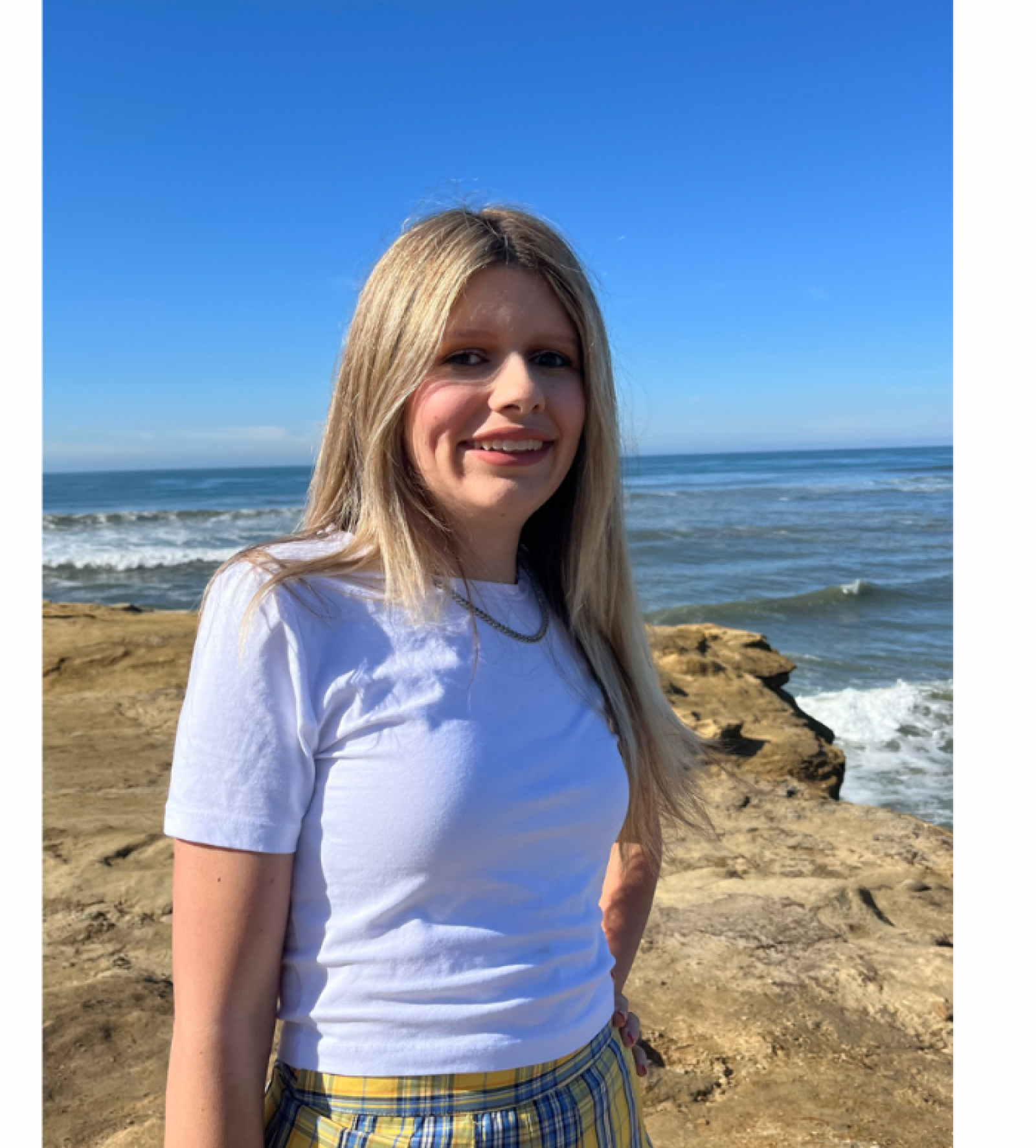 Kiki Ayres standing on edge of a shore