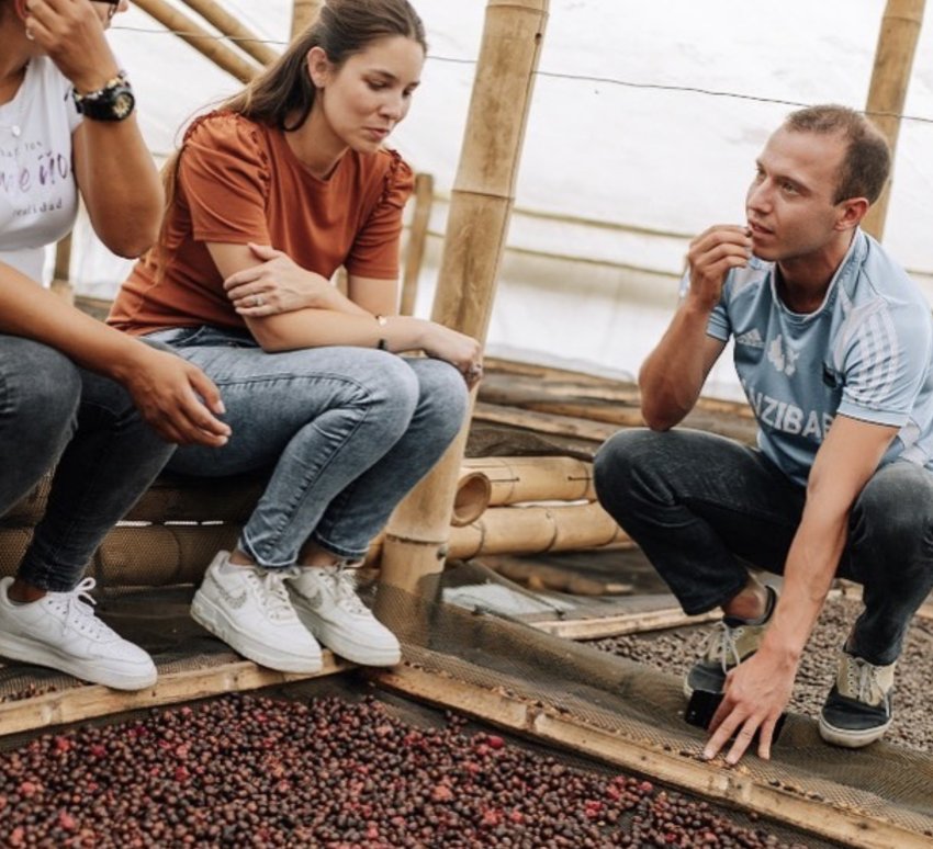 Maria Palacio of Progeny Coffee with two farmers and drying coffee