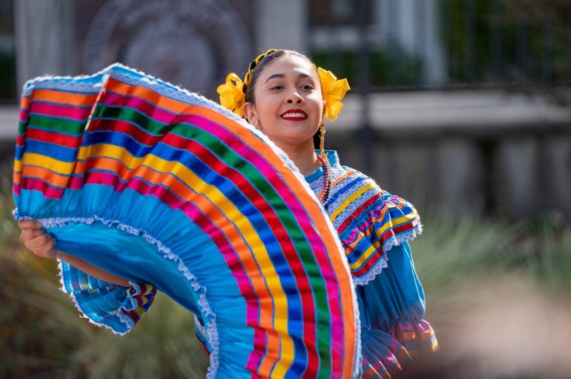 A student dancing at a Dia De Los Muertos event
