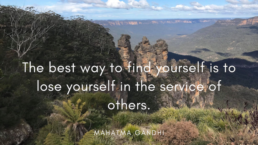Mahatma Gandhi Quote over desert landscape image