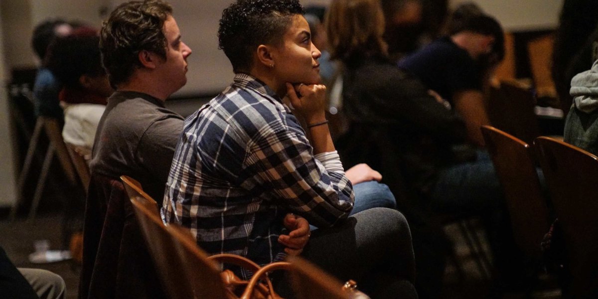 A student watches a craft talk. 