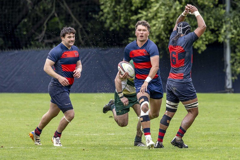 Saint Mary's player Oli Cline '27 runs past a Colorado State defender and a two of his teammates in attempt to score a try. 