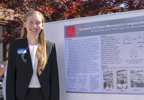 Olivia Eukel next to posterboard for 2023 Student Research and Creative Works Conference