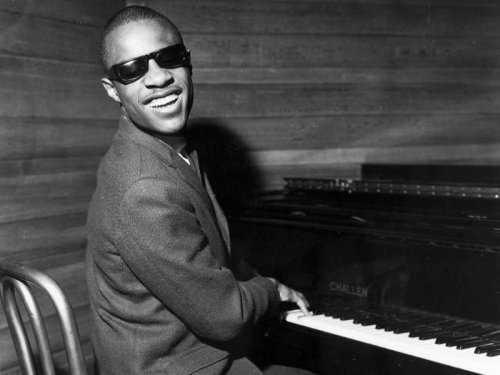 Black and white photo of musician Stevie Wonder at piano