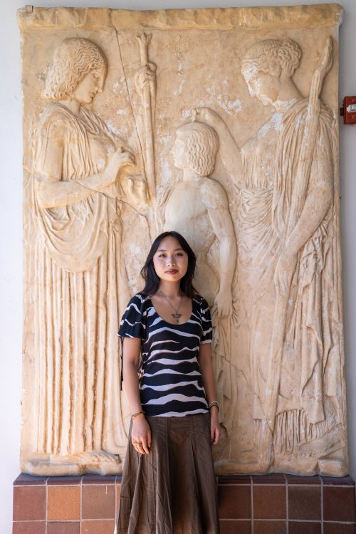 Isabelle Ly posing in from classical artwork on campus